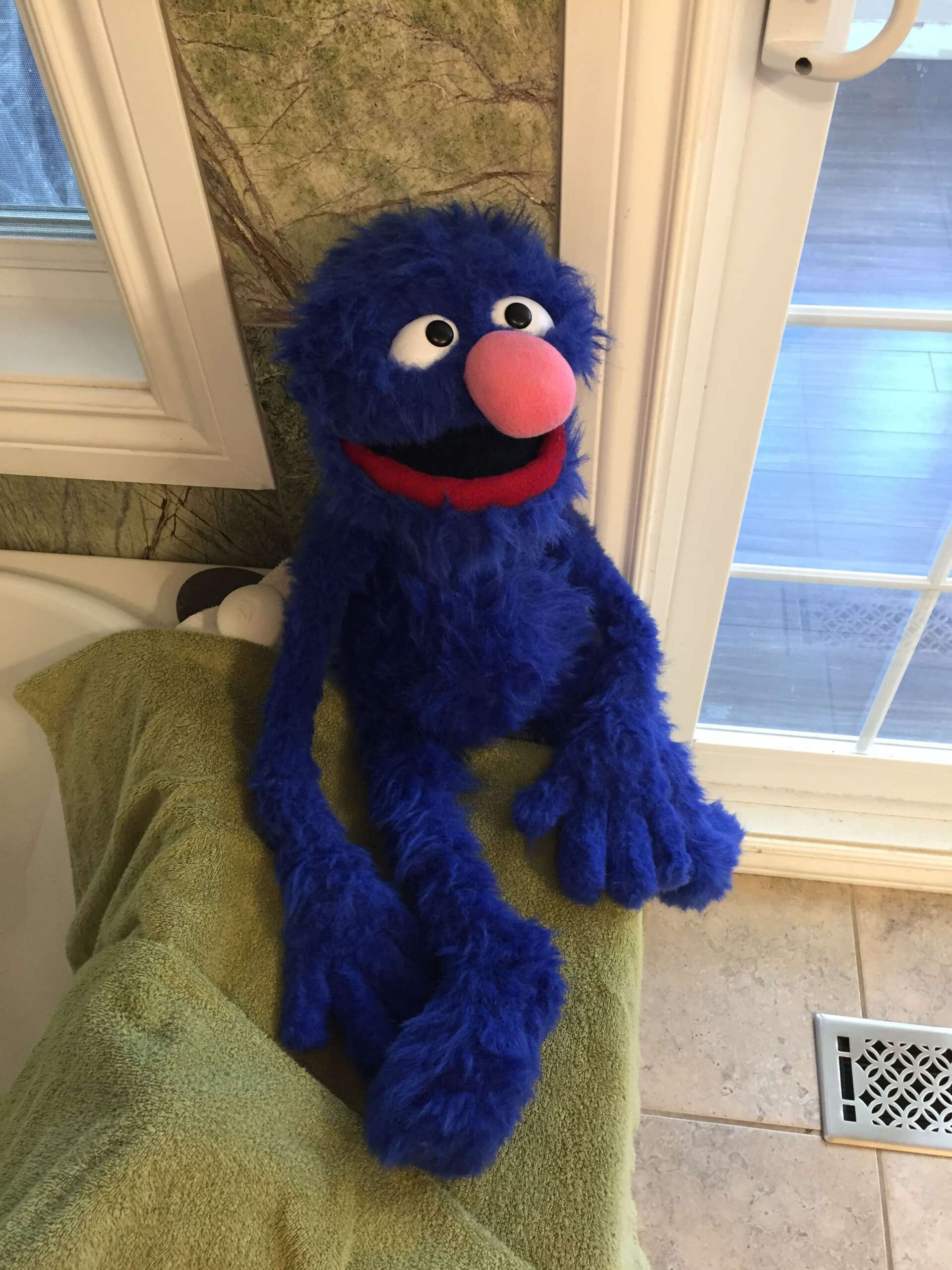 Grover plush Muppet, handmade Handmade Grover plush with a pink nose sitting on a green cushion by a window, a custom Muppet made to order