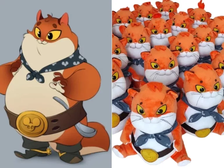 Game studio's orange cat art beside the custom plush copies made from it, navy bandana and gold belt buckle