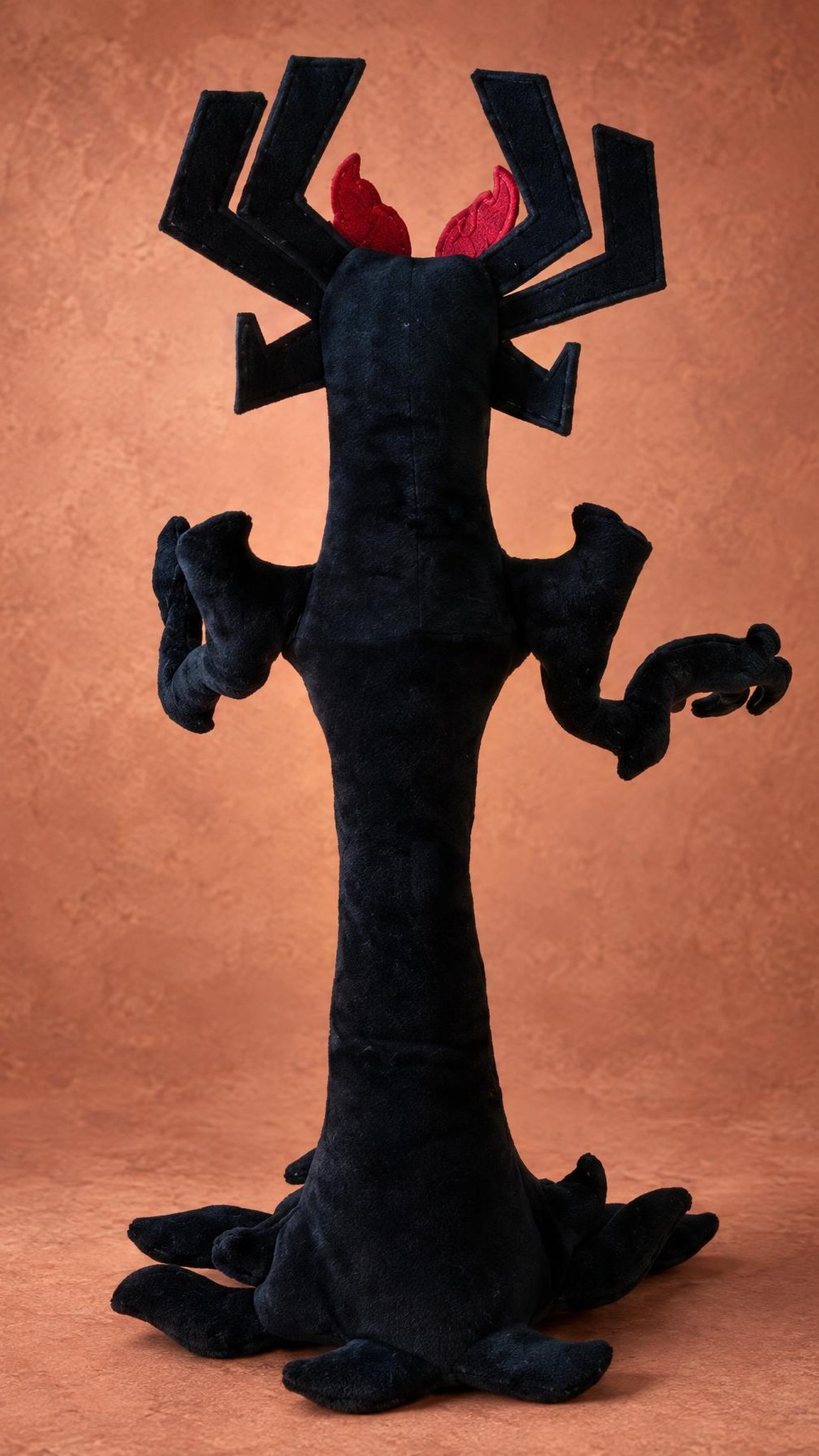 Aku plush from behind, black branching horns and a tree-like body, a custom Samurai Jack toy made to order