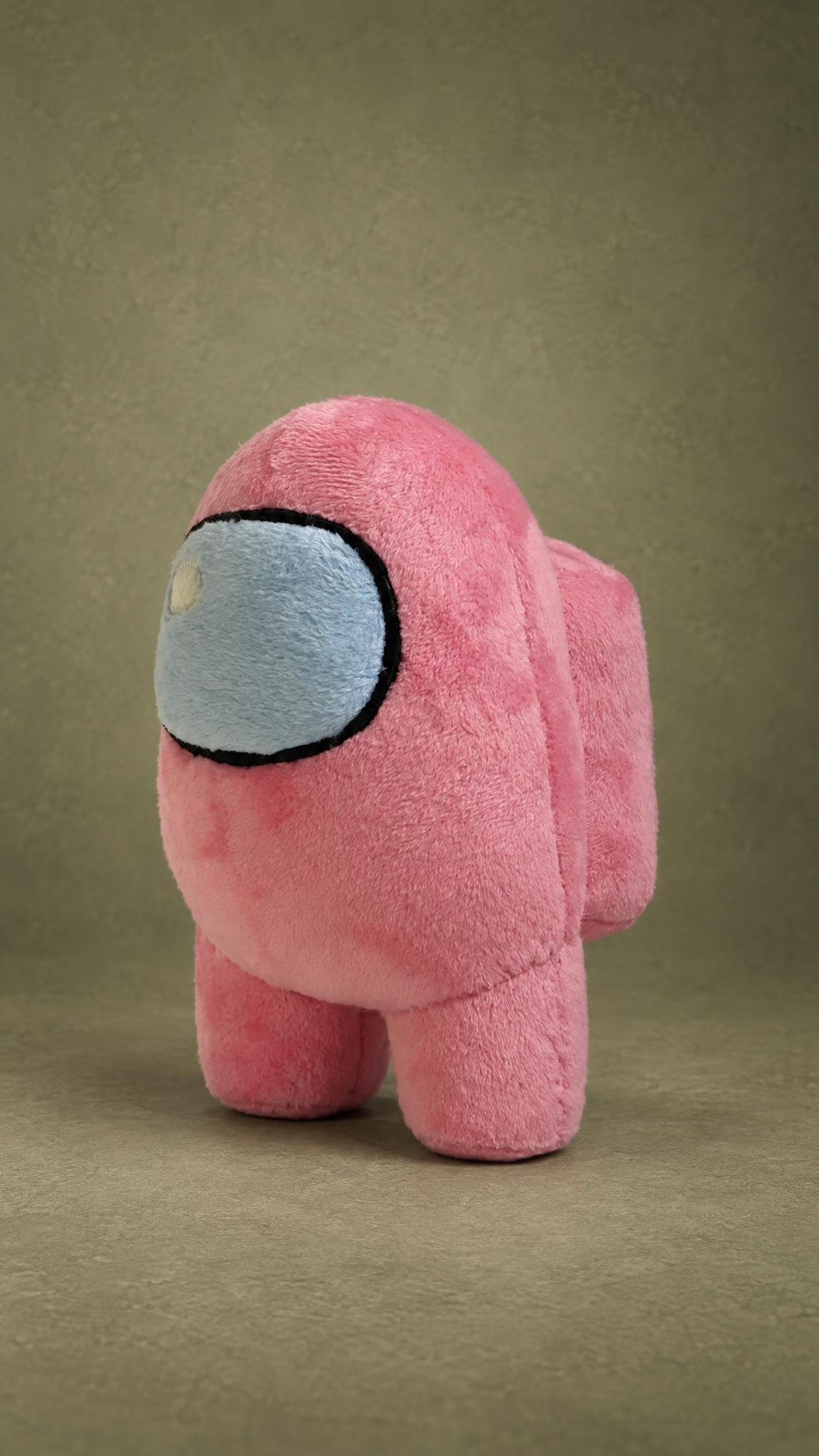 Handmade pink Among Us plush turned to the side, with a black-outlined blue visor and a backpack
