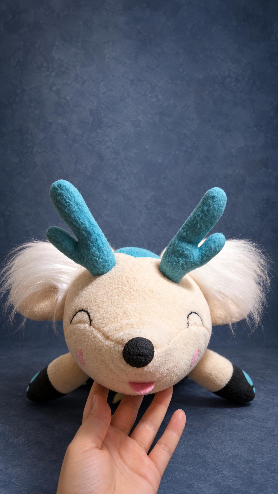 Antlered cream fox plushie with an embroidered smile and pink cheeks, handmade from a couple's picture