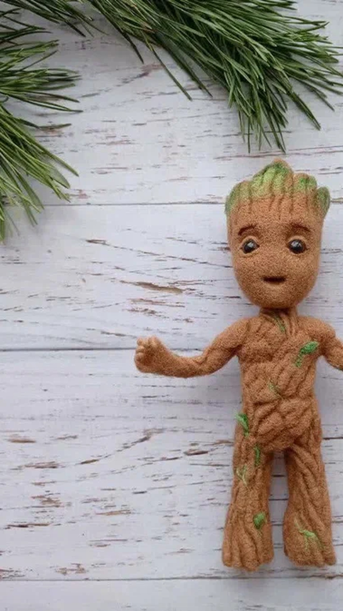 Baby Groot plush with his arms open among pine branches, a needle-felted Marvel character made to order