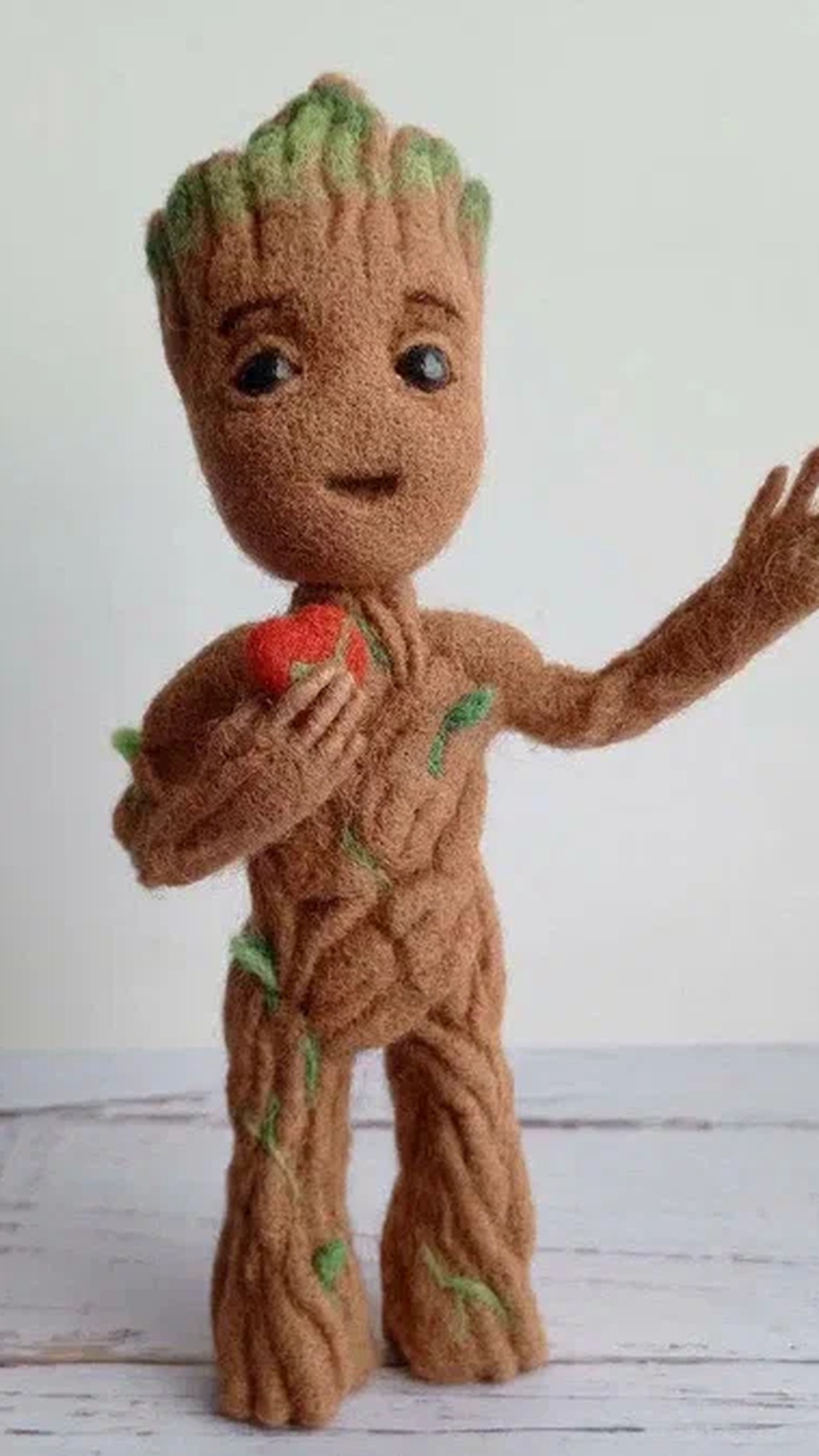 Baby Groot plush holding a small red heart to his chest, a needle-felted Marvel fan toy made to order