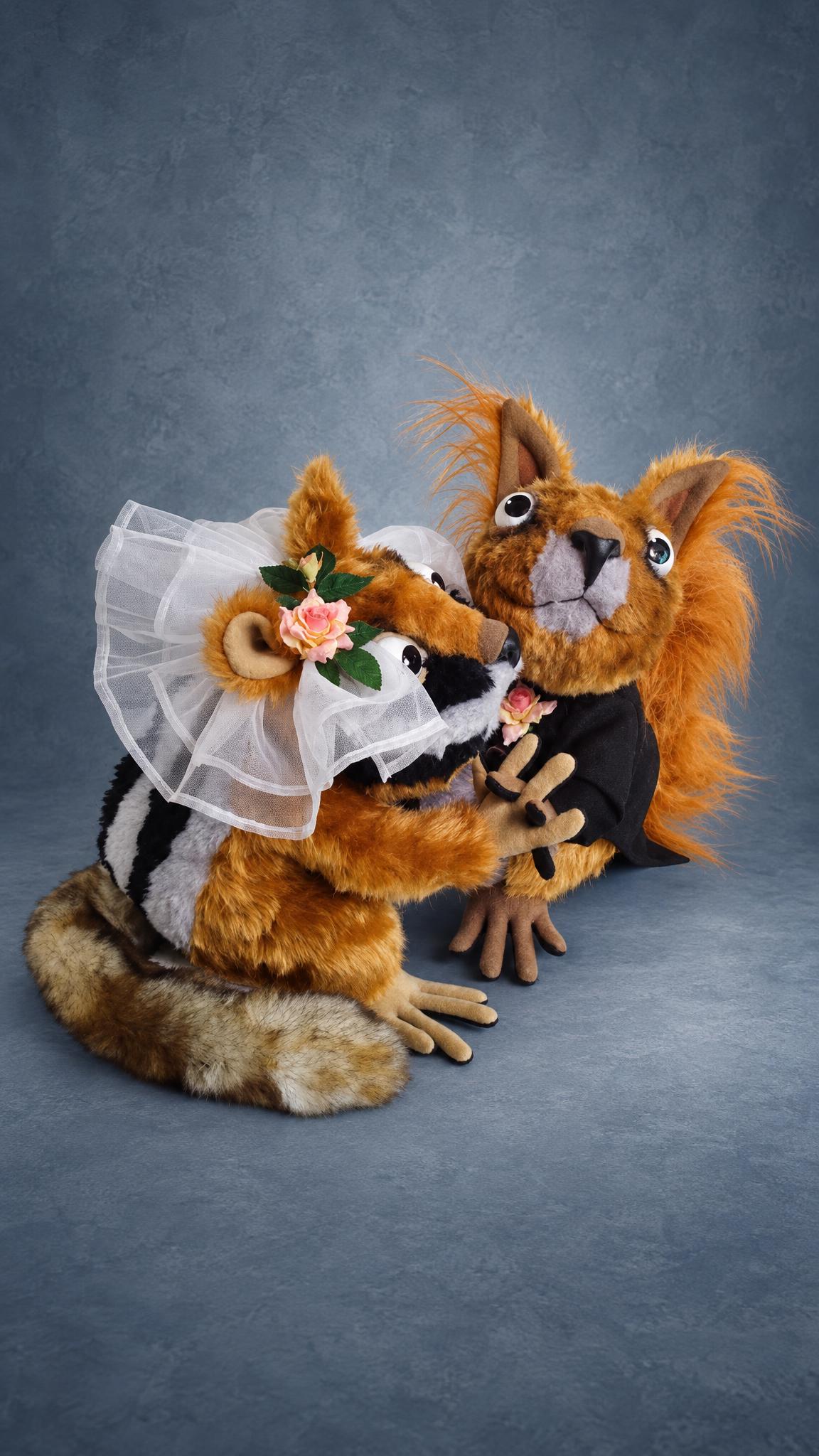 Handmade bride and groom plush for newlyweds: badger in a tulle veil hugs a ginger squirrel in a black tuxedo