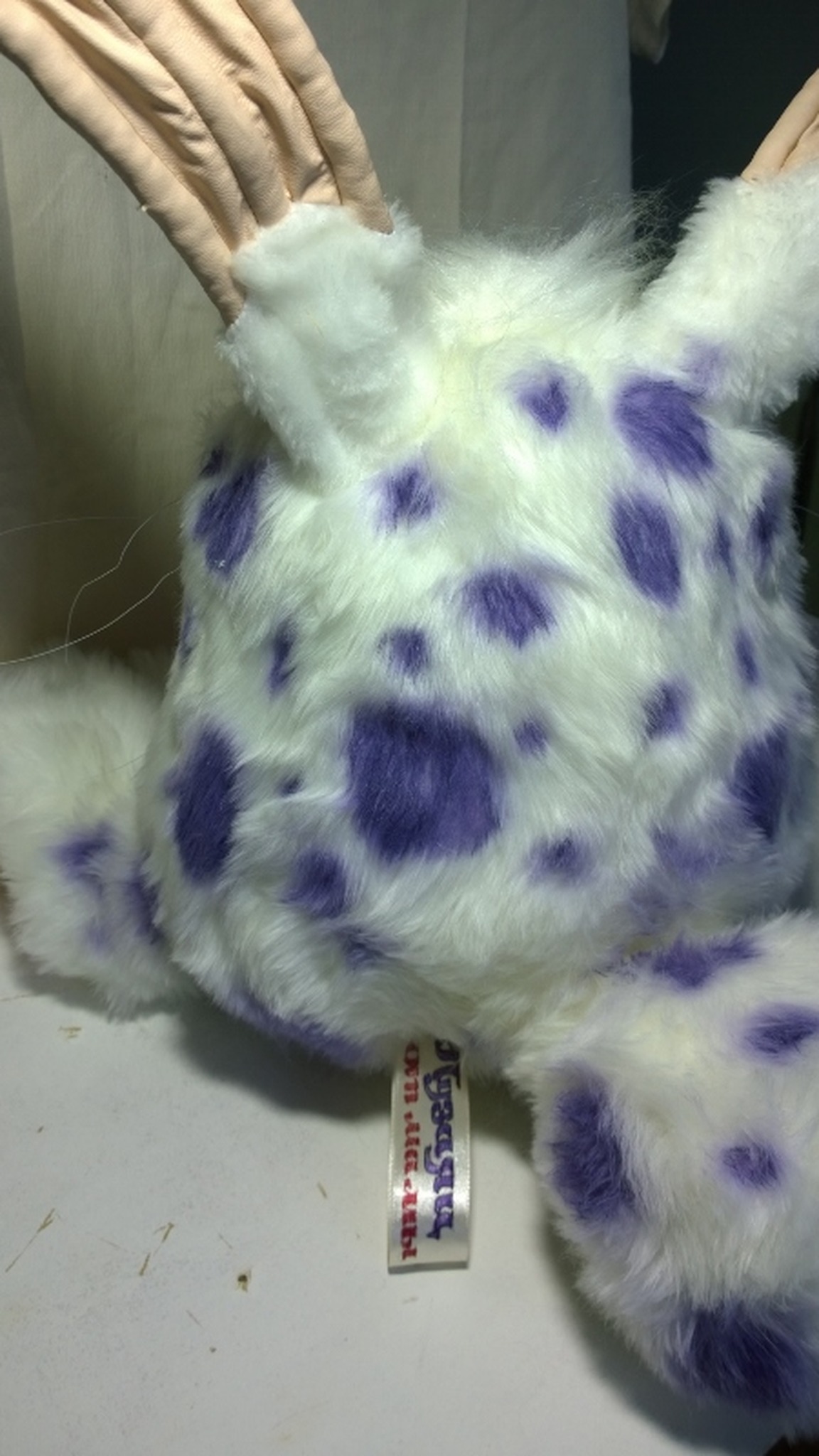 Purple-spotted back of a handmade Blabbit plush with our label in the seam, custom My Singing Monsters toy