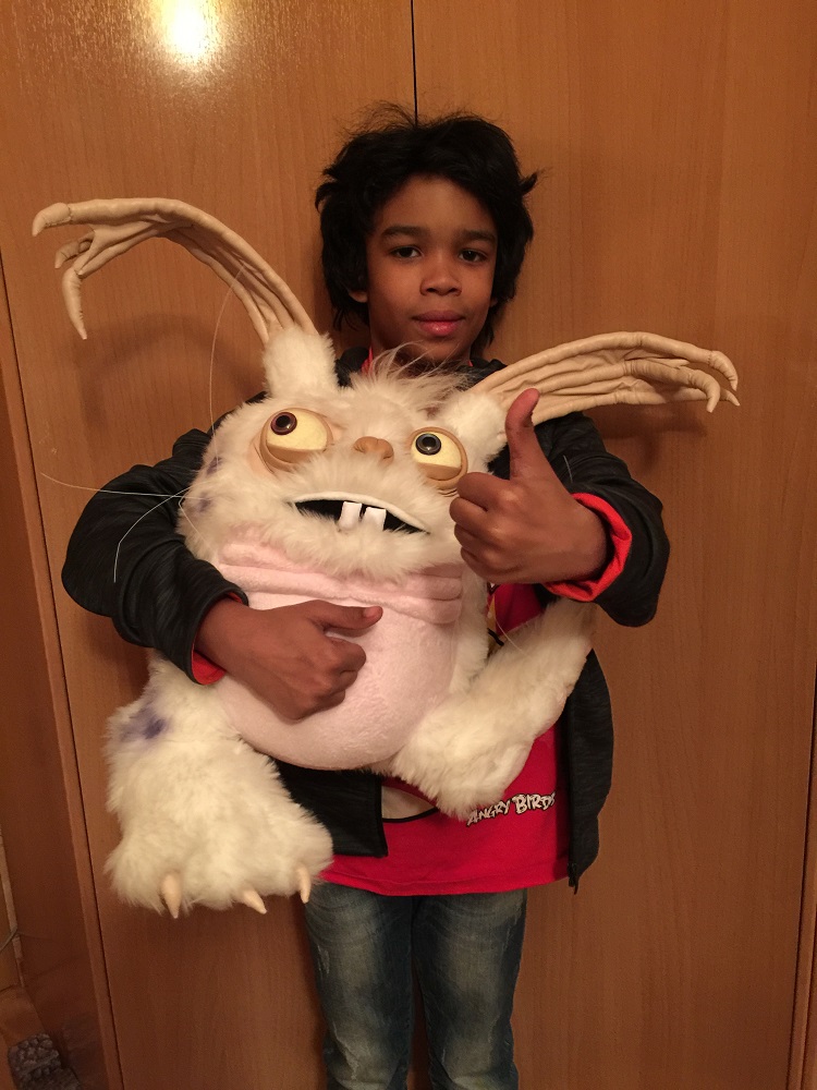 Boy hugging the Blabbit plush we made for him in 2016 and giving a thumbs up, a custom My Singing Monsters gift