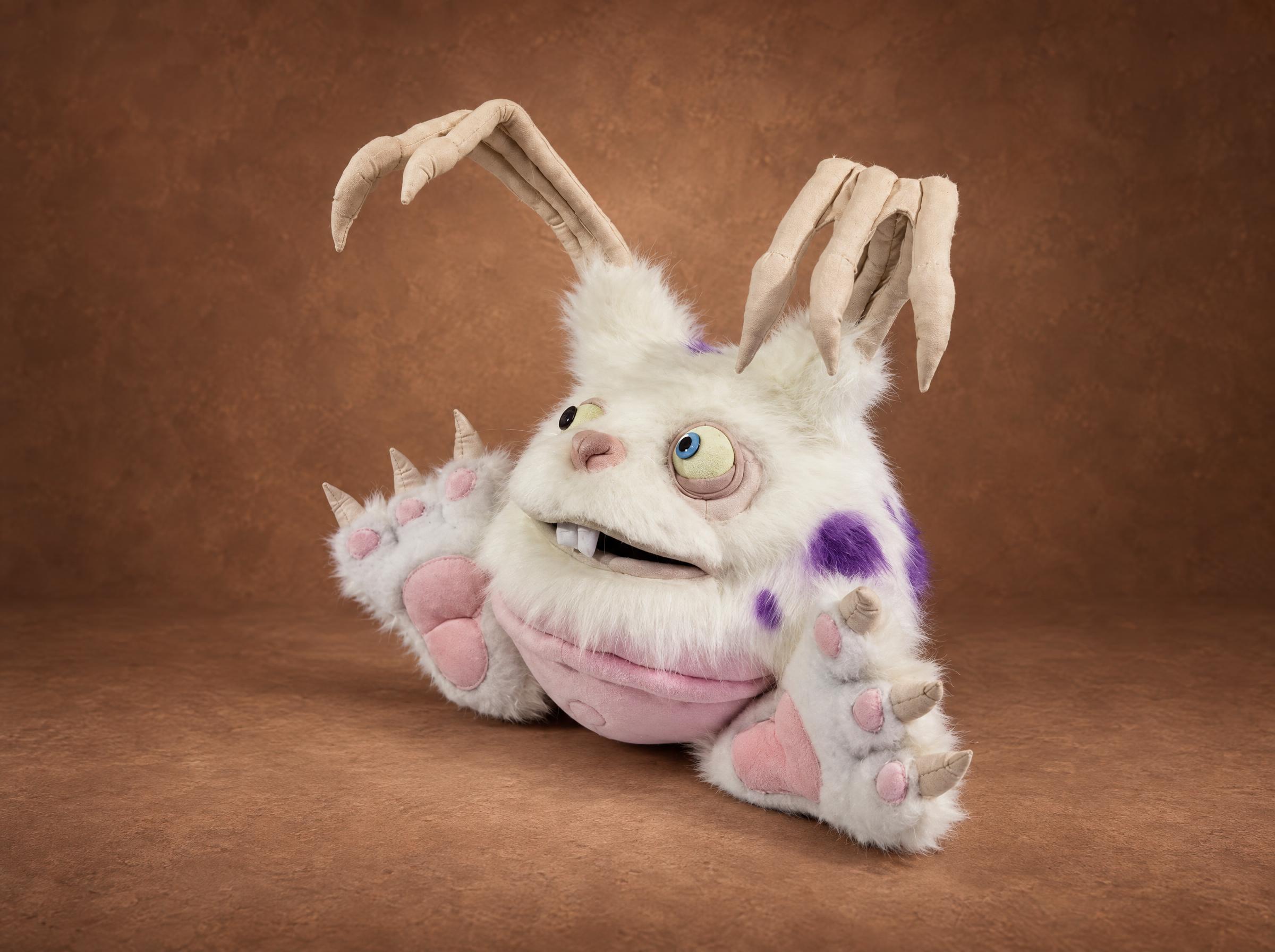 MSM Blabbit plush with buck teeth and a wide grin MSM Blabbit plush leaning back with a buck-tooth grin, mismatched eyes and pink paw pads, custom made to order