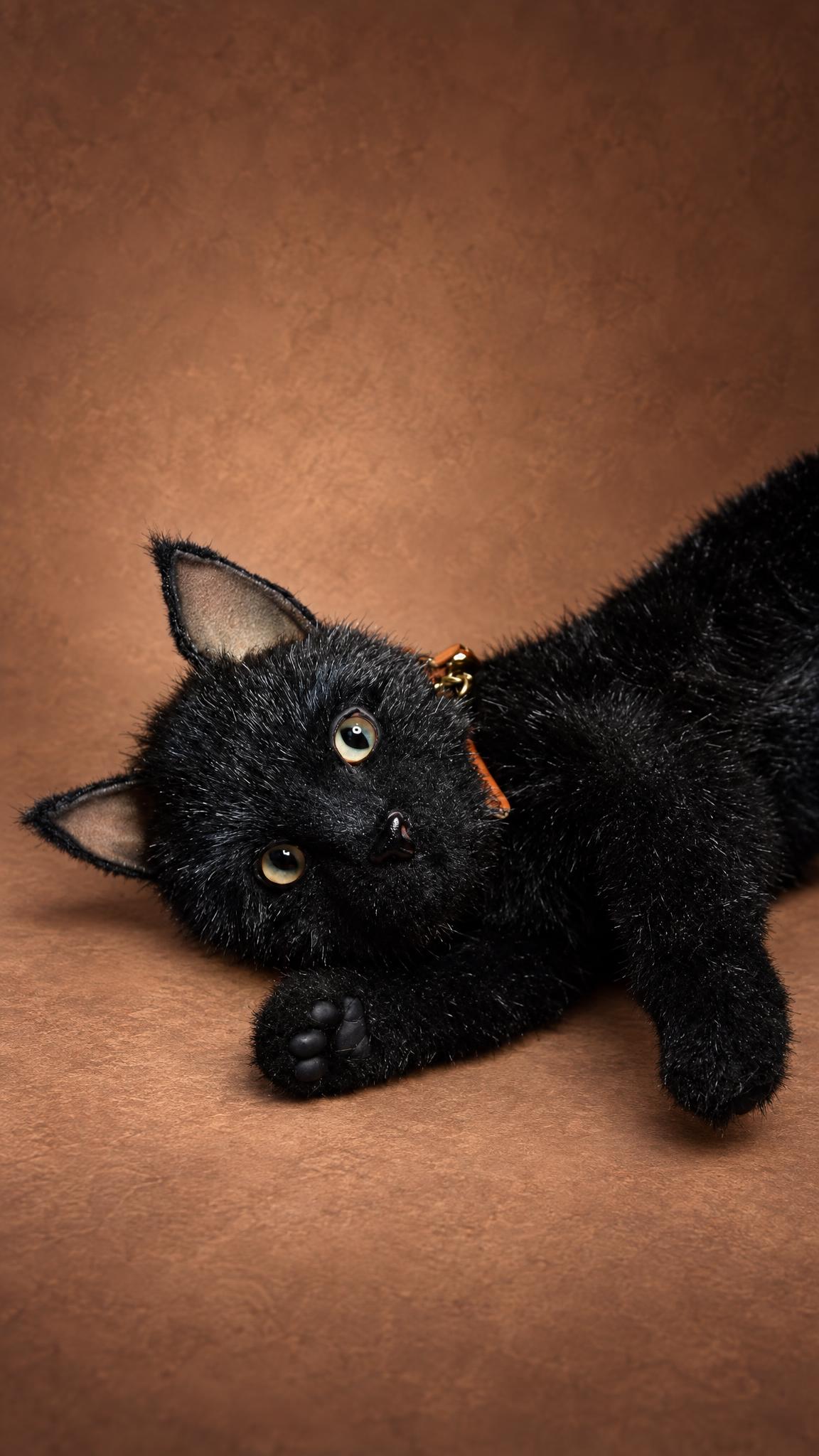 Poseable black cat stuffed animal rolling over with a paw raised, handmade to order