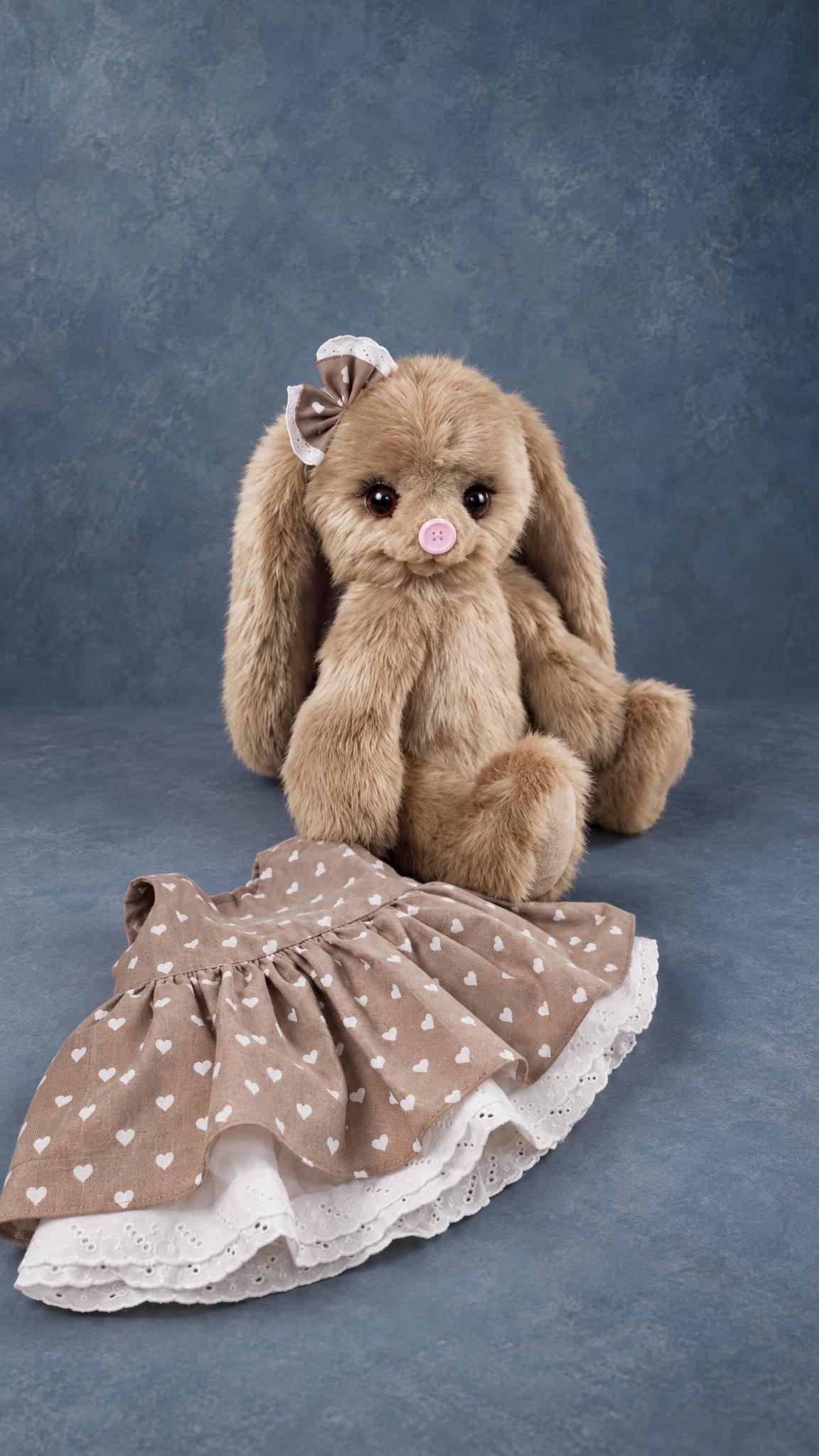 Bunny plush prototype with its removable heart-print dress beside it, teddy-style, made to order for a brand