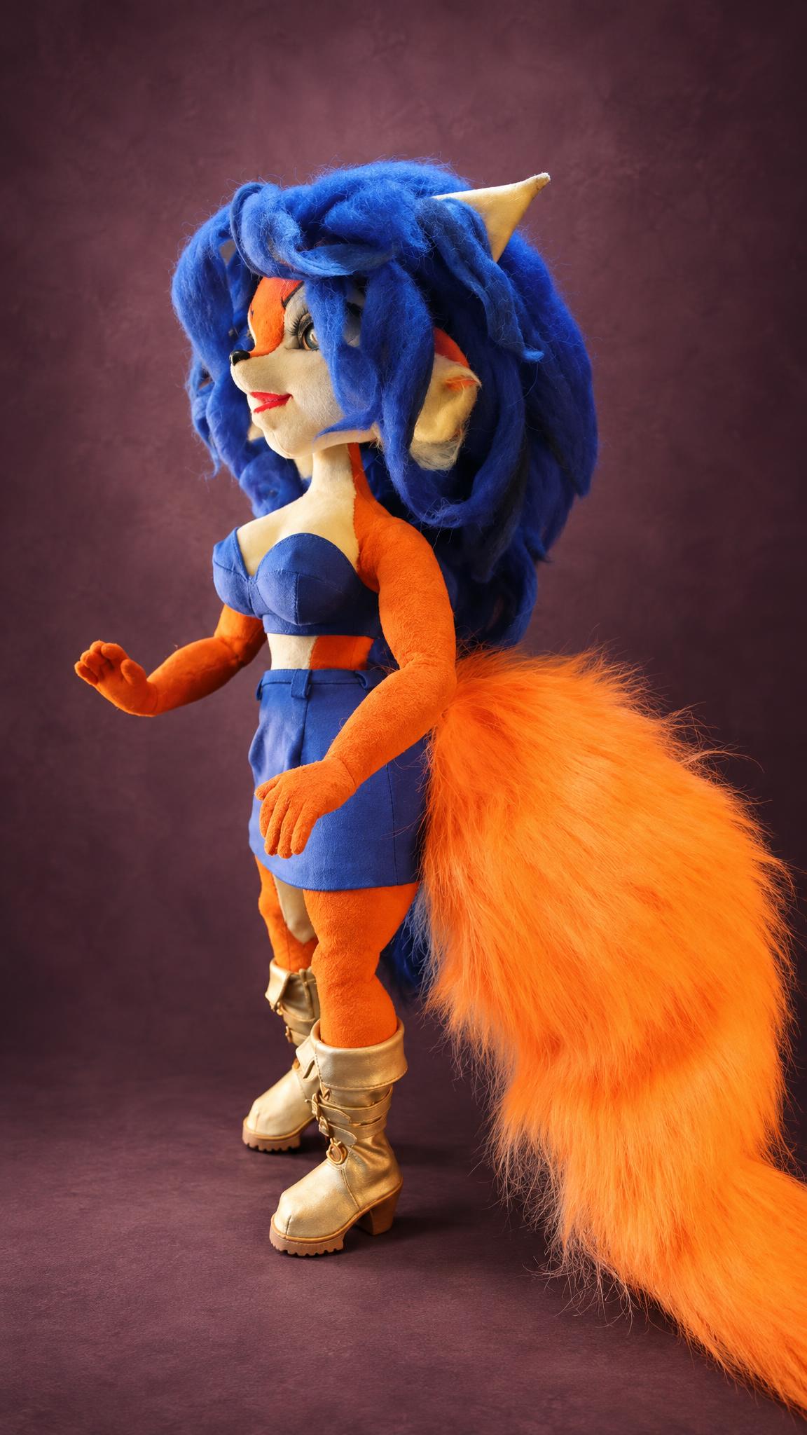 Handmade Carmelita Fox doll in a blue top and skirt with gold boots and an orange tail, a custom Sly Cooper doll