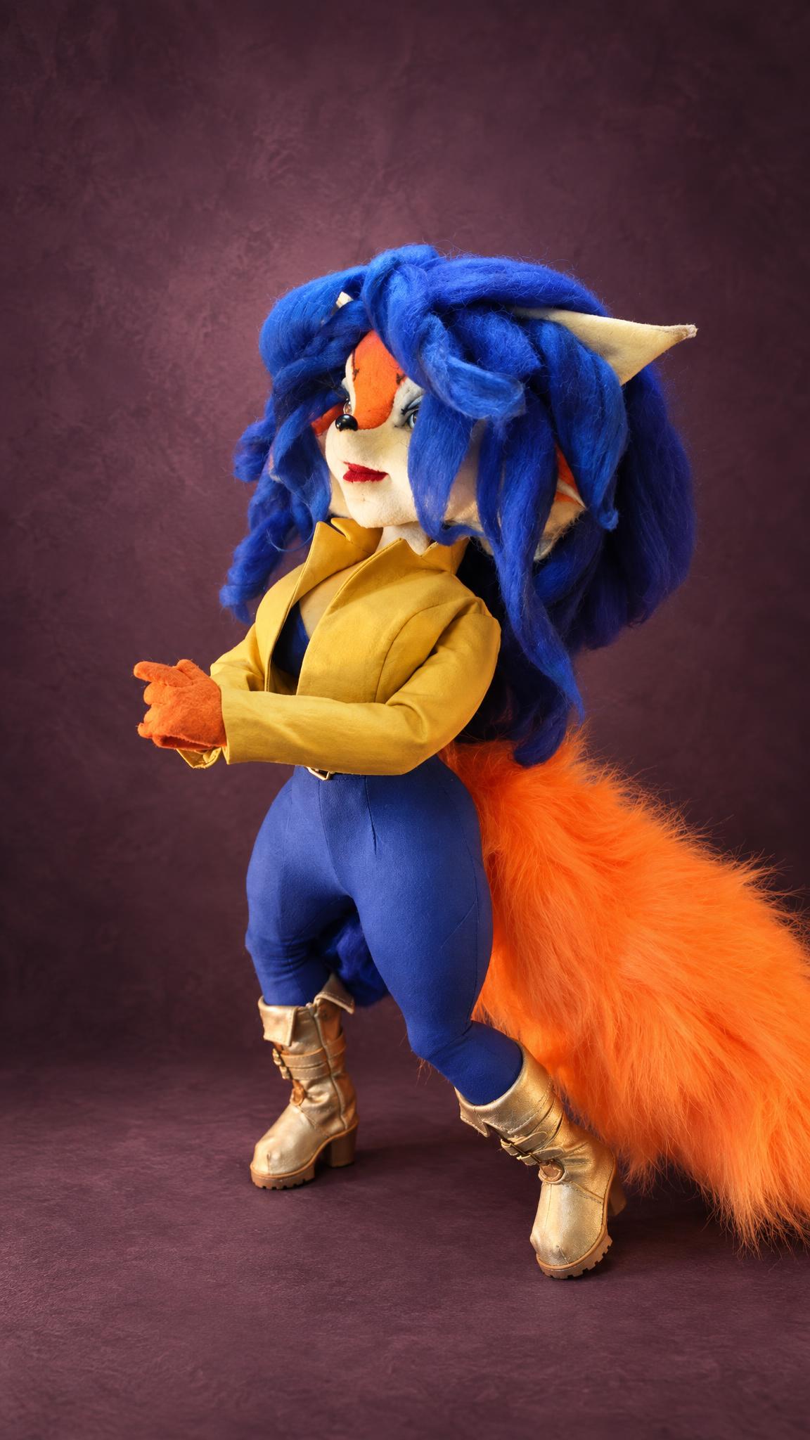 Handmade Carmelita Fox doll posed in her yellow jacket and blue leggings, a custom poseable Sly Cooper doll