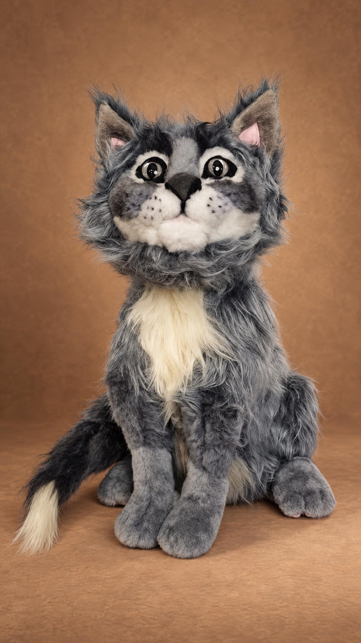 Realistic grey cat plush looking up, big glass eyes, pink inner ears and fluffy grey fur, a custom pet replica