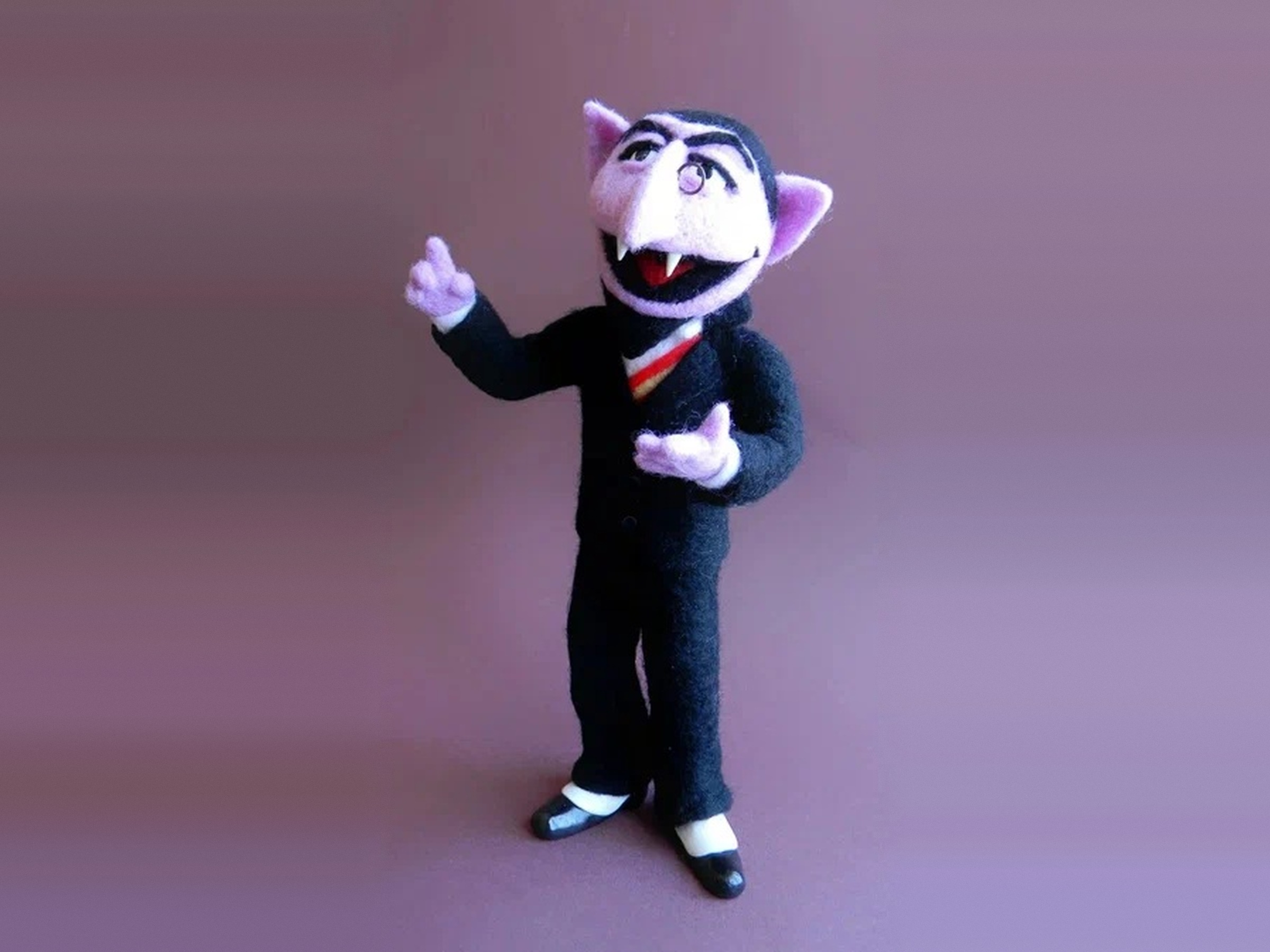 Count von Count doll with his monocle Count von Count doll without his cape, showing the monocle, black felt suit and sash, handmade to order