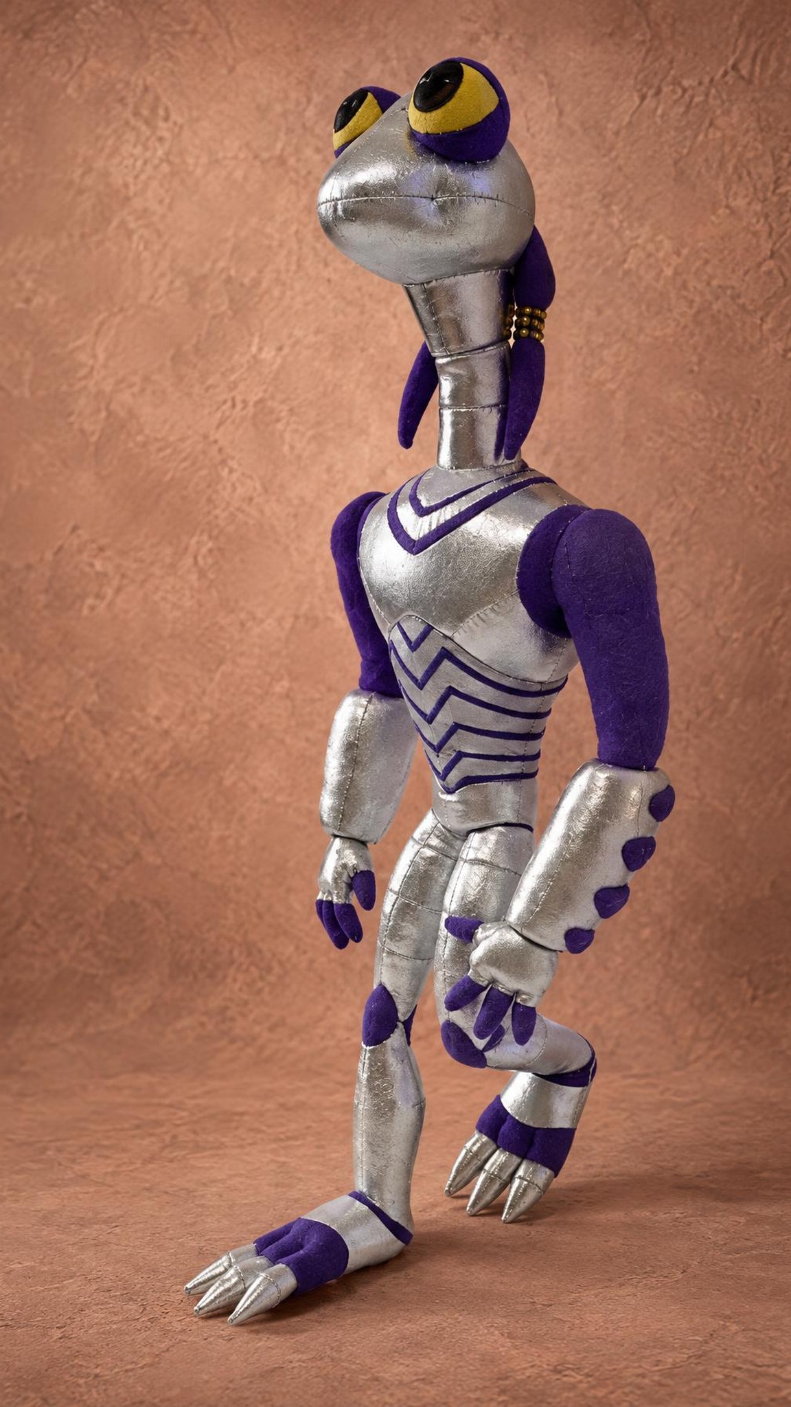 Handmade Croakagy alien plush leaning back, silver body with purple stripes, custom Space Dogs villain toy