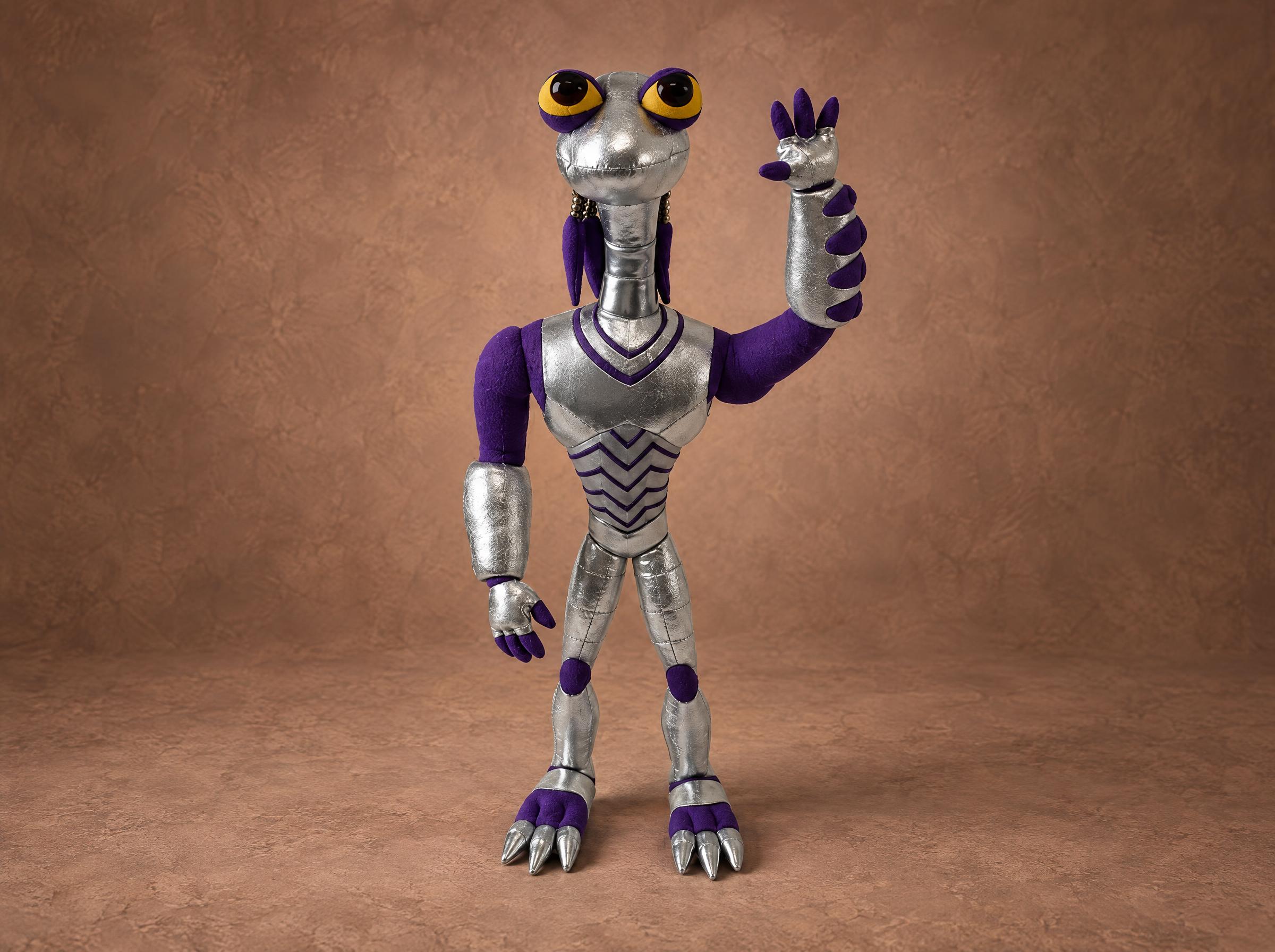 Croakagy plush from Space Dogs, a custom silver and purple alien toy sewn to order, waving one clawed hand