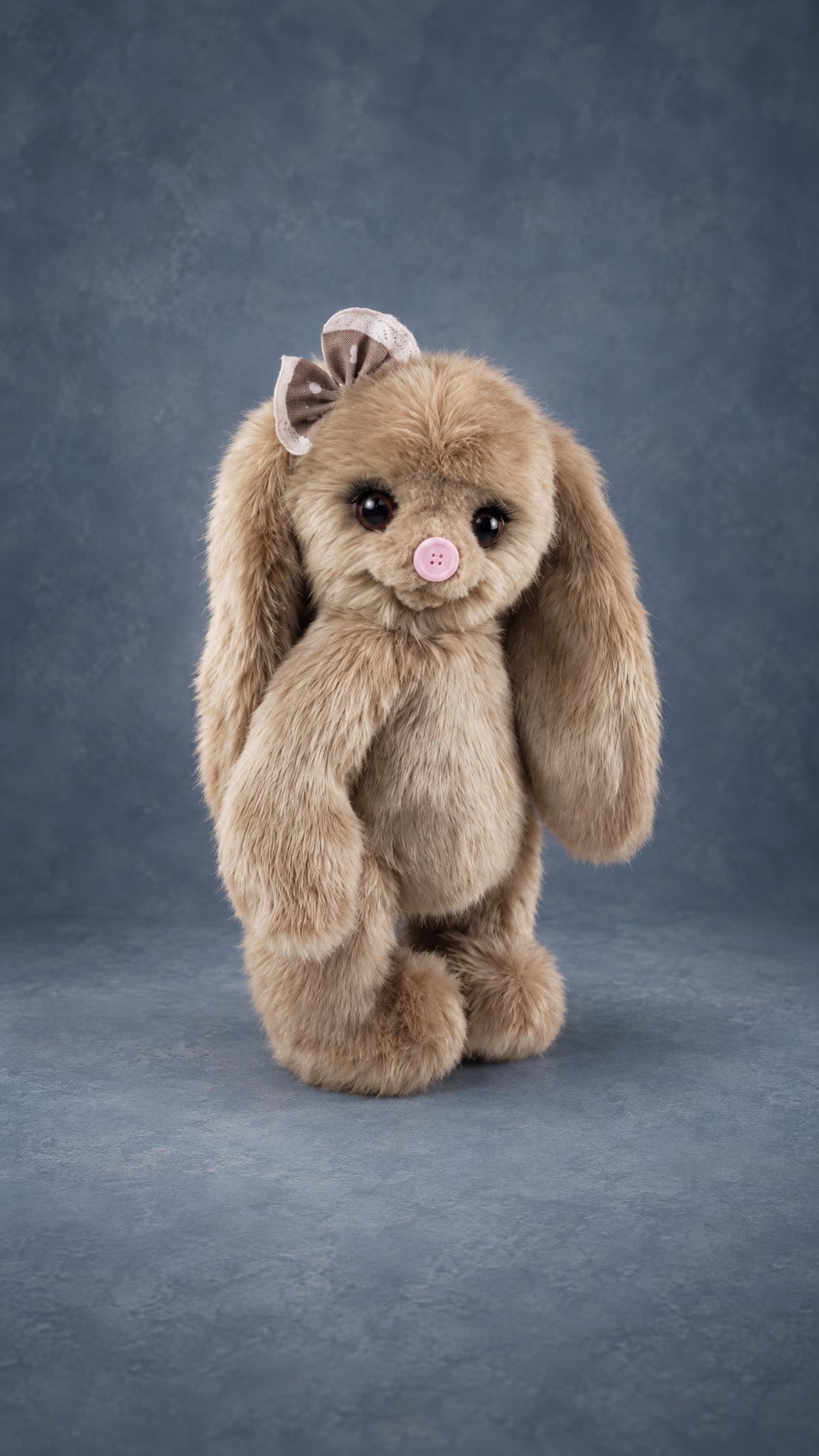 Custom bunny plush sample for a toy brand, beige faux fur, long ears and a pink button nose, handmade