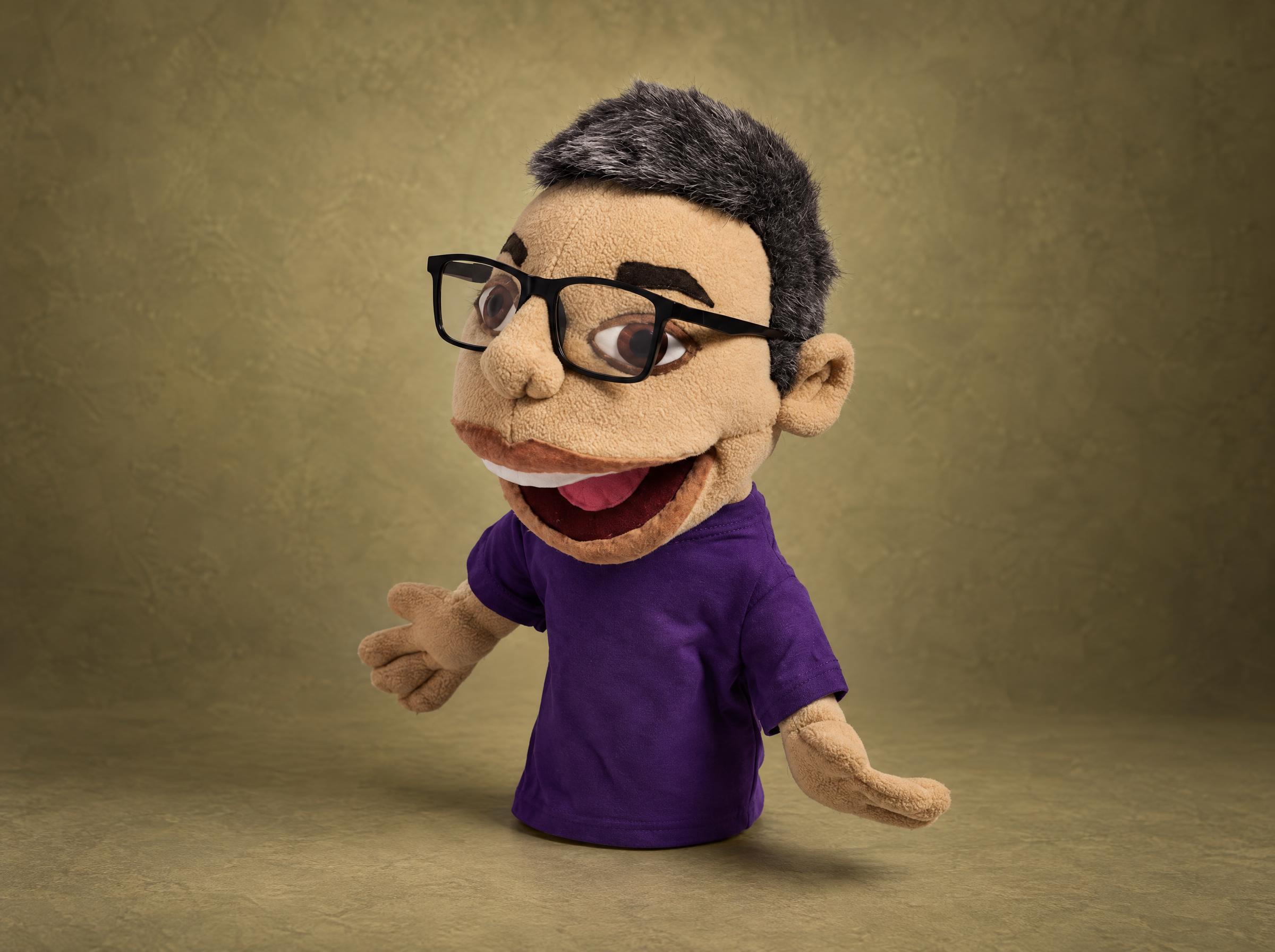 Custom hand puppet made to order from a blogger's photos: gray hair, black glasses, purple T-shirt, open mouth