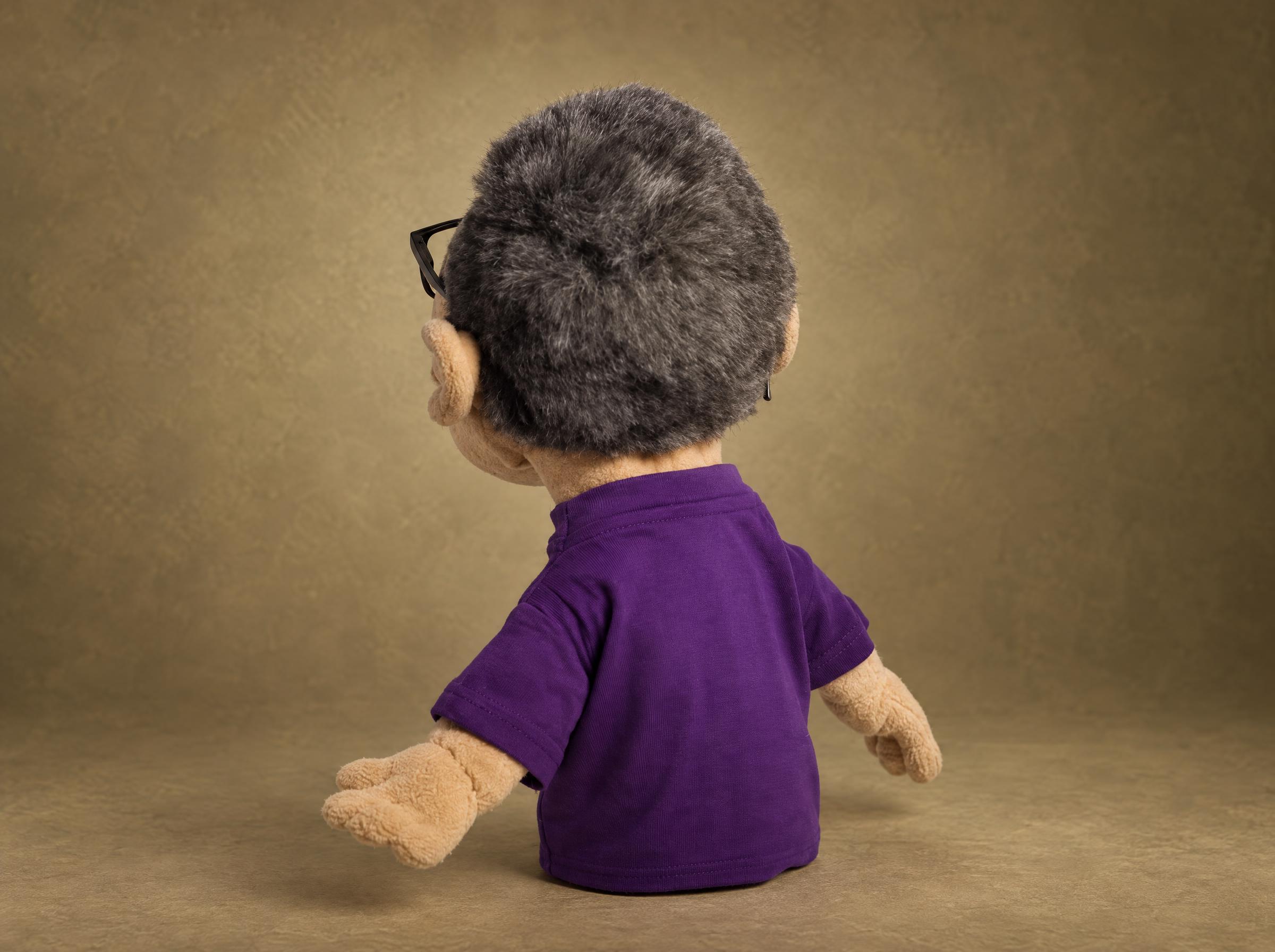 Custom lookalike hand puppet with gray fur hair and a purple T-shirt, sewn by hand from a blogger's photos