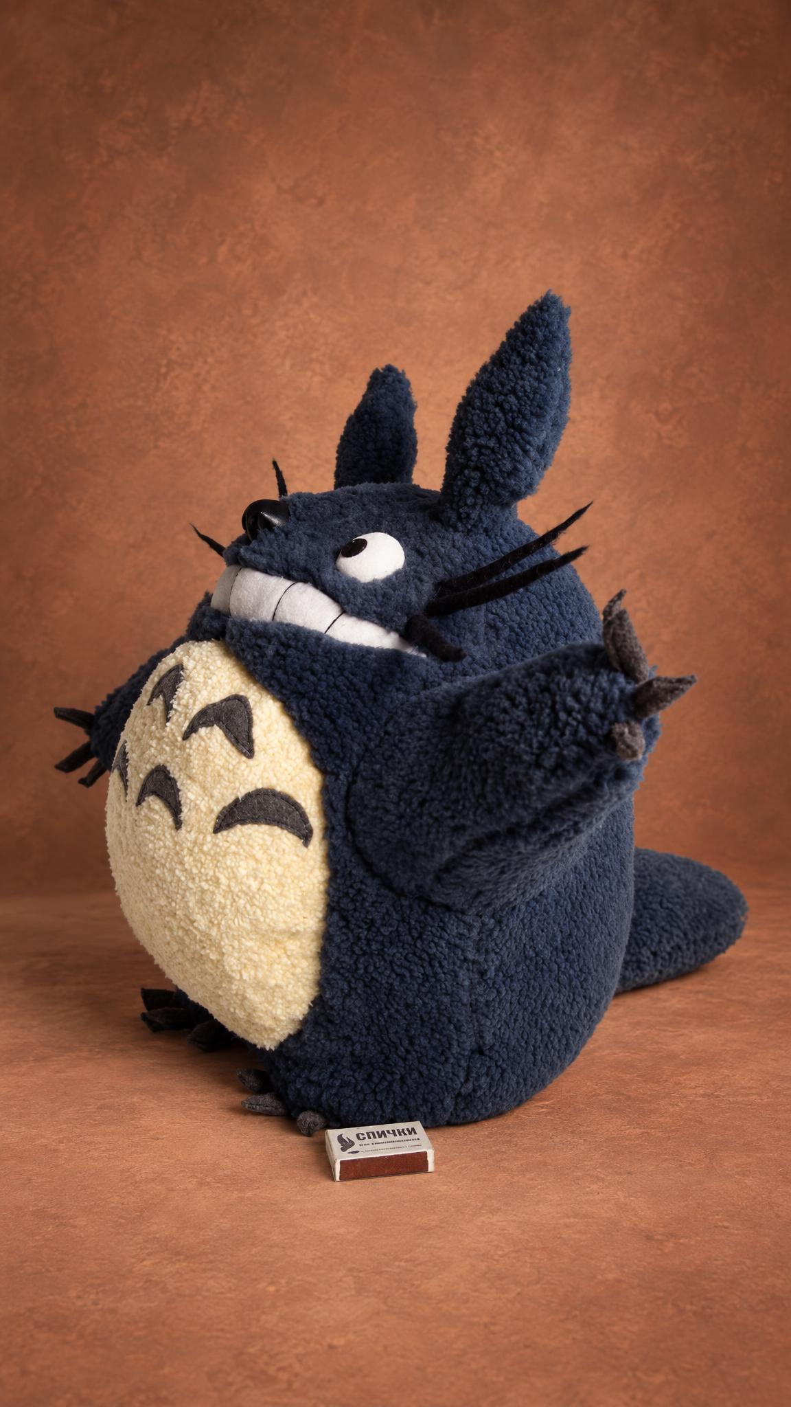 Custom Totoro plush in curly navy fleece, handmade in 2009: grinning, eyes up, a soft tail and cream belly
