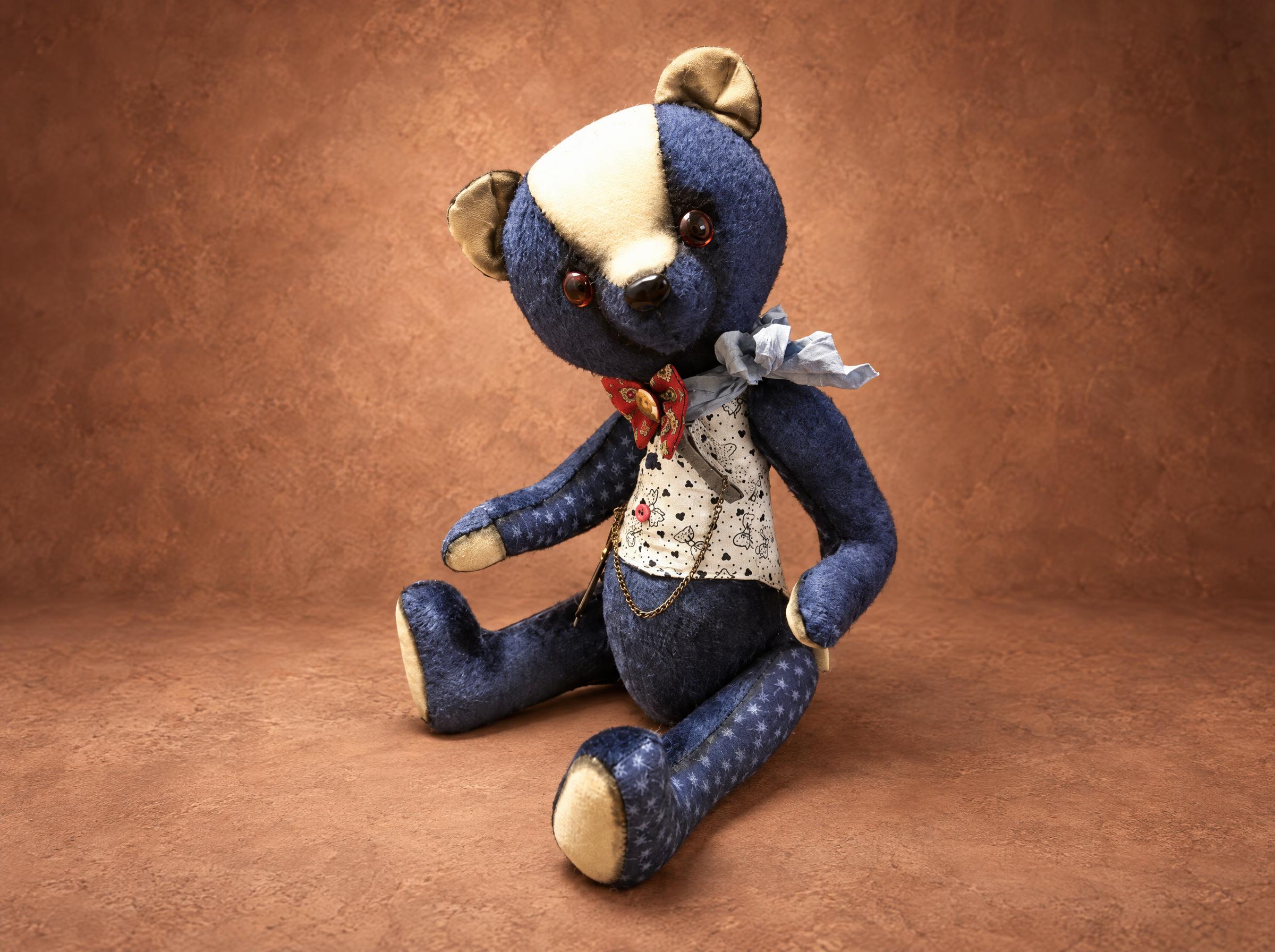 Custom teddy bear from a sketch: navy patterned fabric, cream muzzle, floral vest and a red bow, made to order