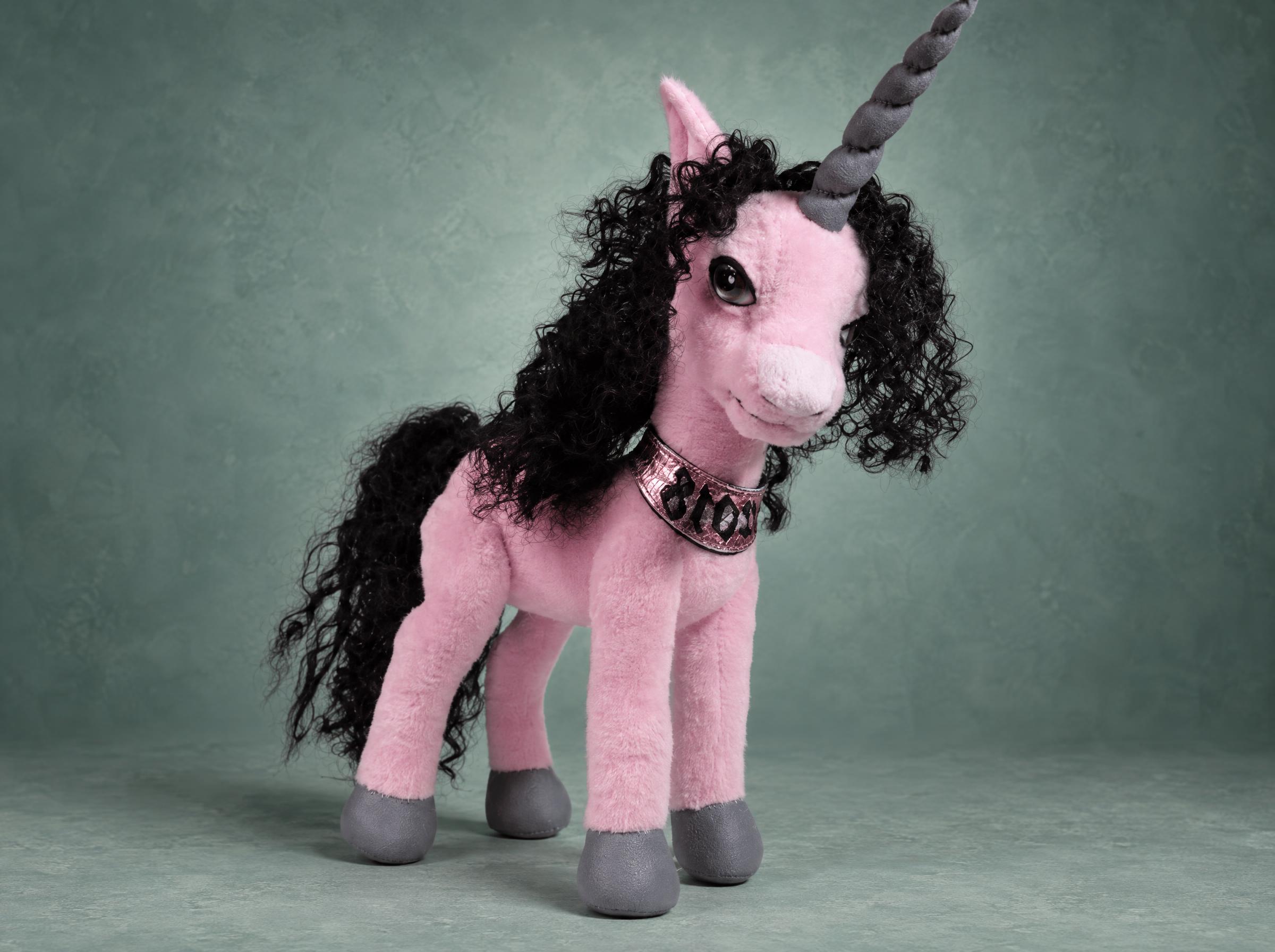 Custom unicorn plush made to order: a pink handmade unicorn with a black curly mane, grey horn and hooves