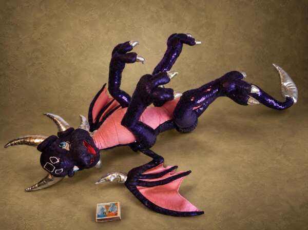 Poseable Cynder plush lying on her back with all four legs bent, a custom Legend of Spyro dragon plush