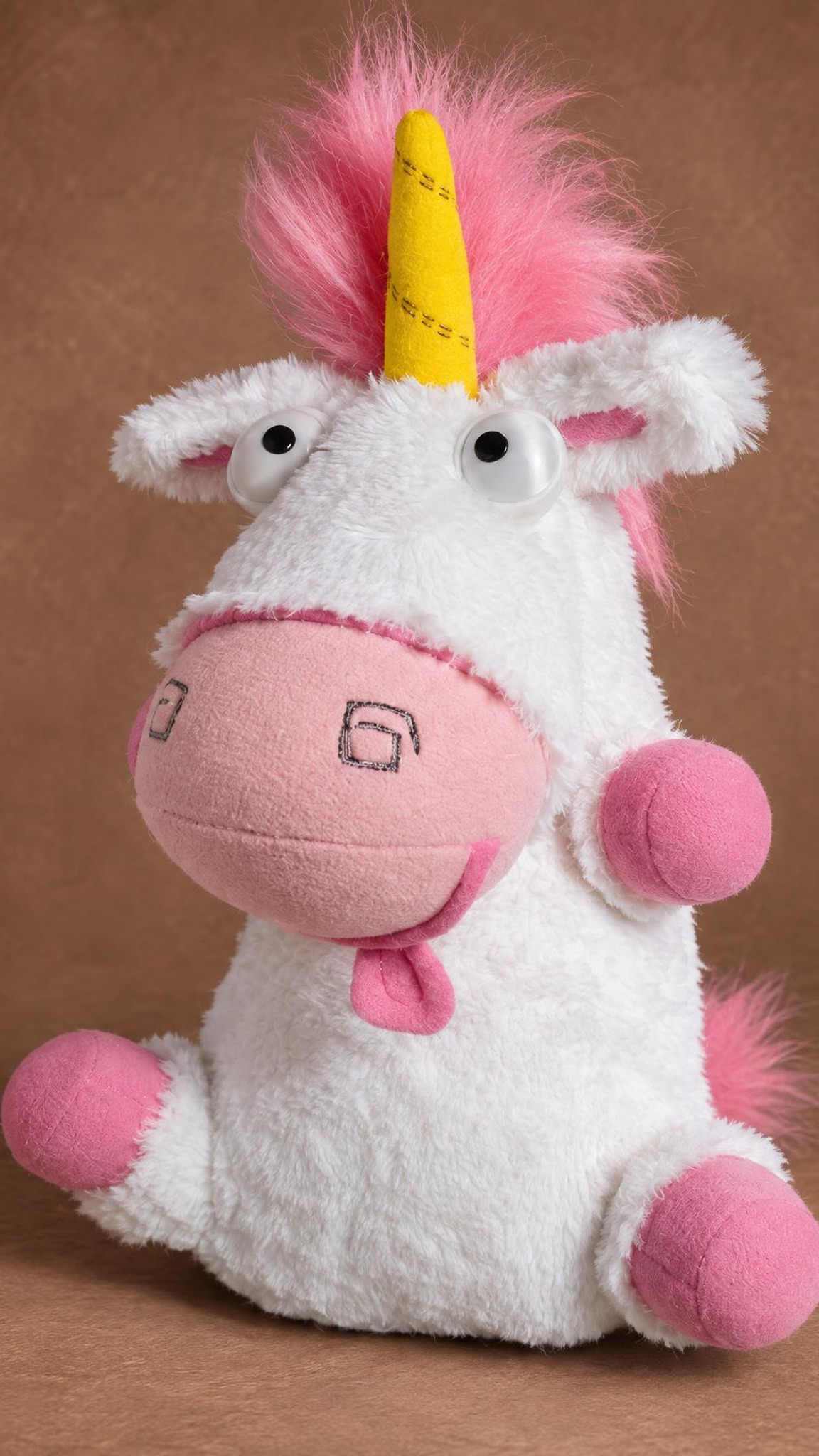 Despicable Me unicorn plush with its pink tongue out and fluffy pink mane, a custom stuffed unicorn sewn to order