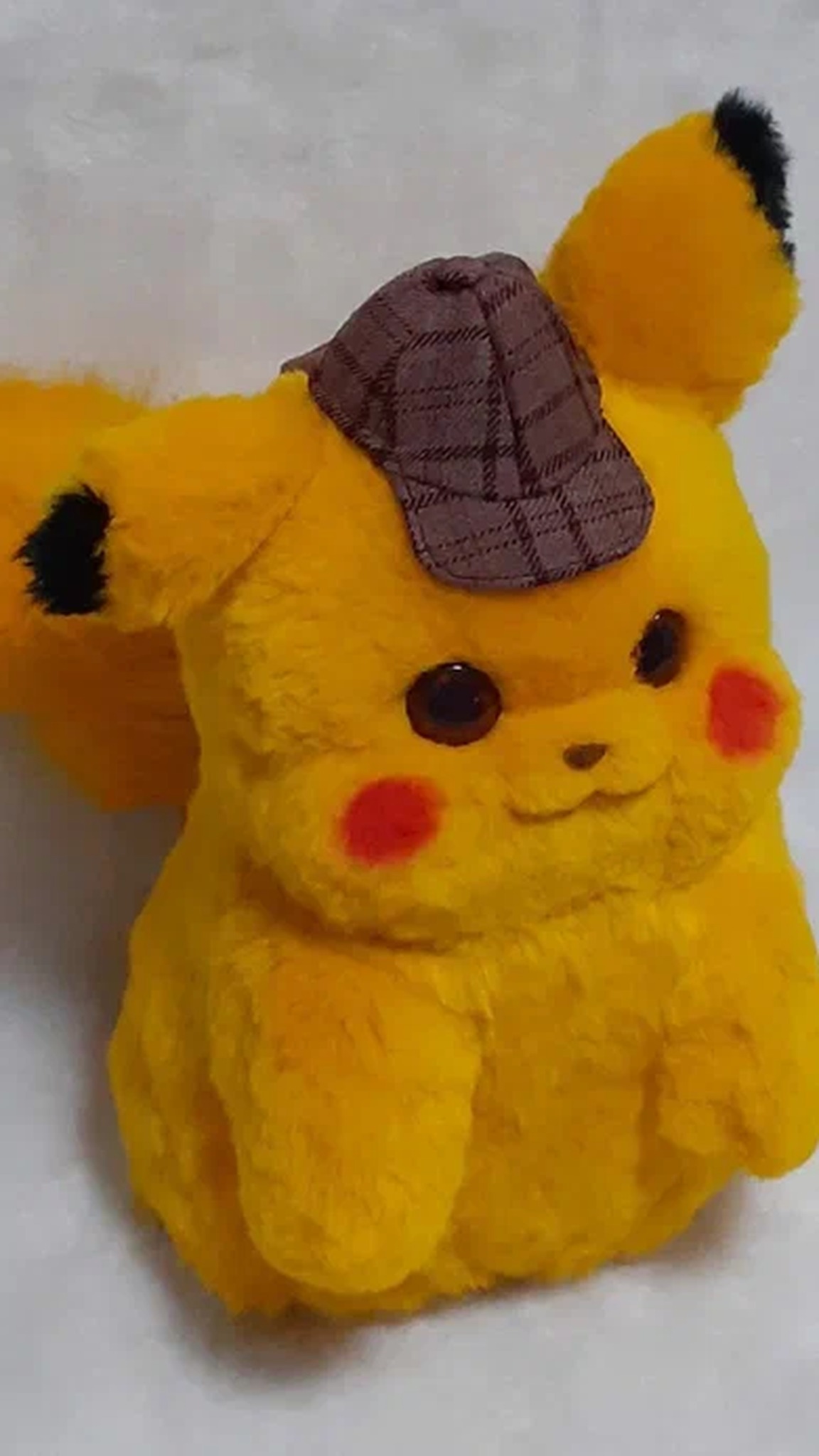 Handmade Detective Pikachu plush in a brown plaid deerstalker cap, with fluffy yellow fur and black ear tips