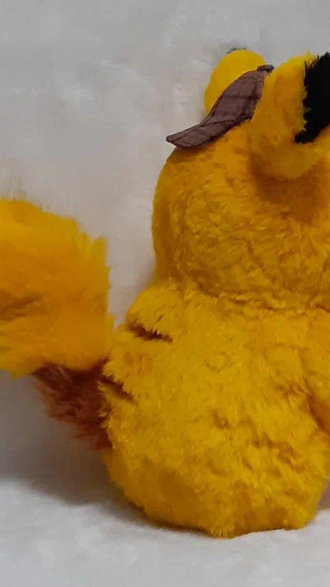 Detective Pikachu plush from behind, with a fluffy yellow tail and black-tipped ears, a custom handmade plush