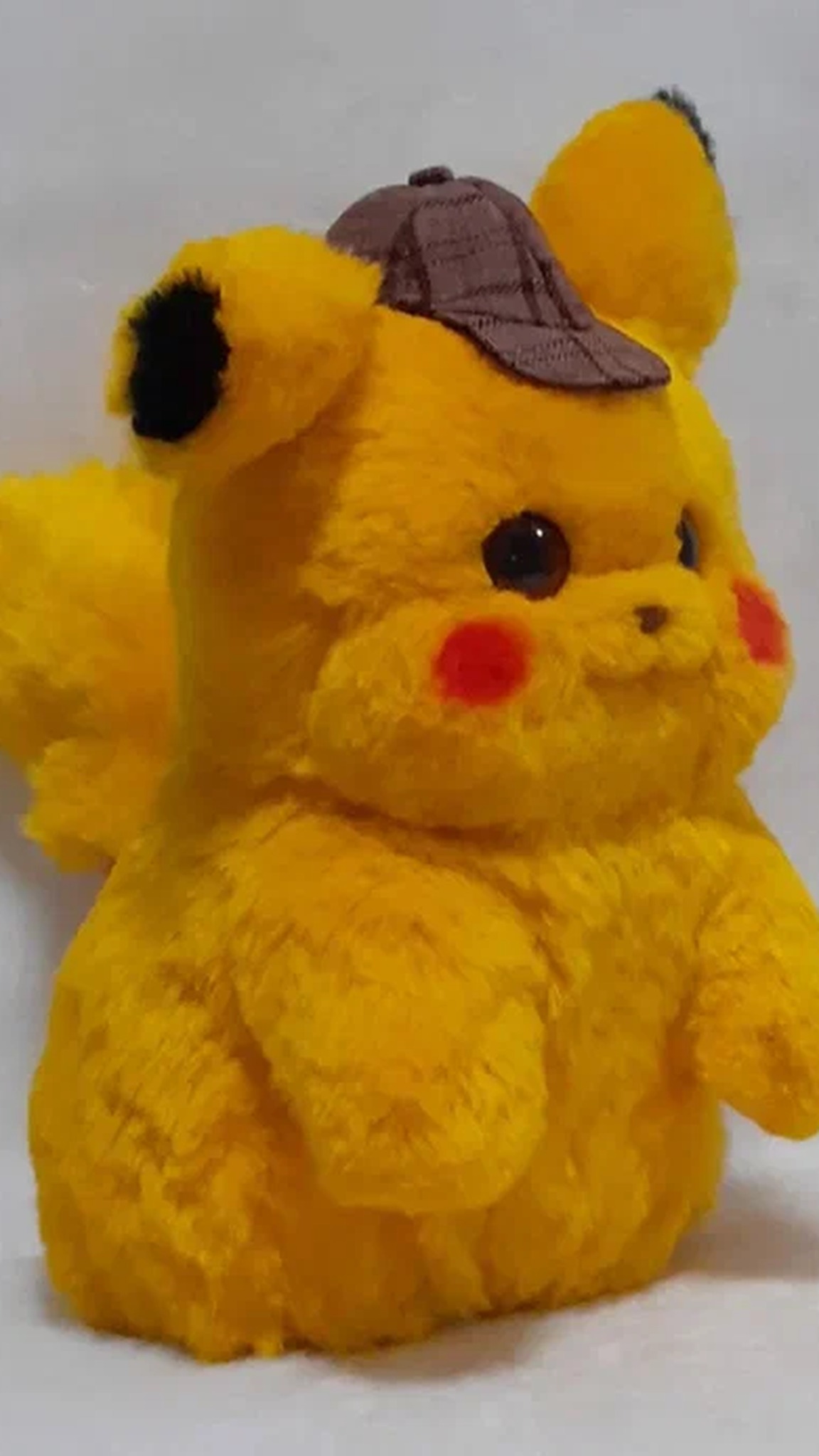 Custom Detective Pikachu soft toy with long fluffy yellow faux fur, red cheeks and a plaid cap, made to order