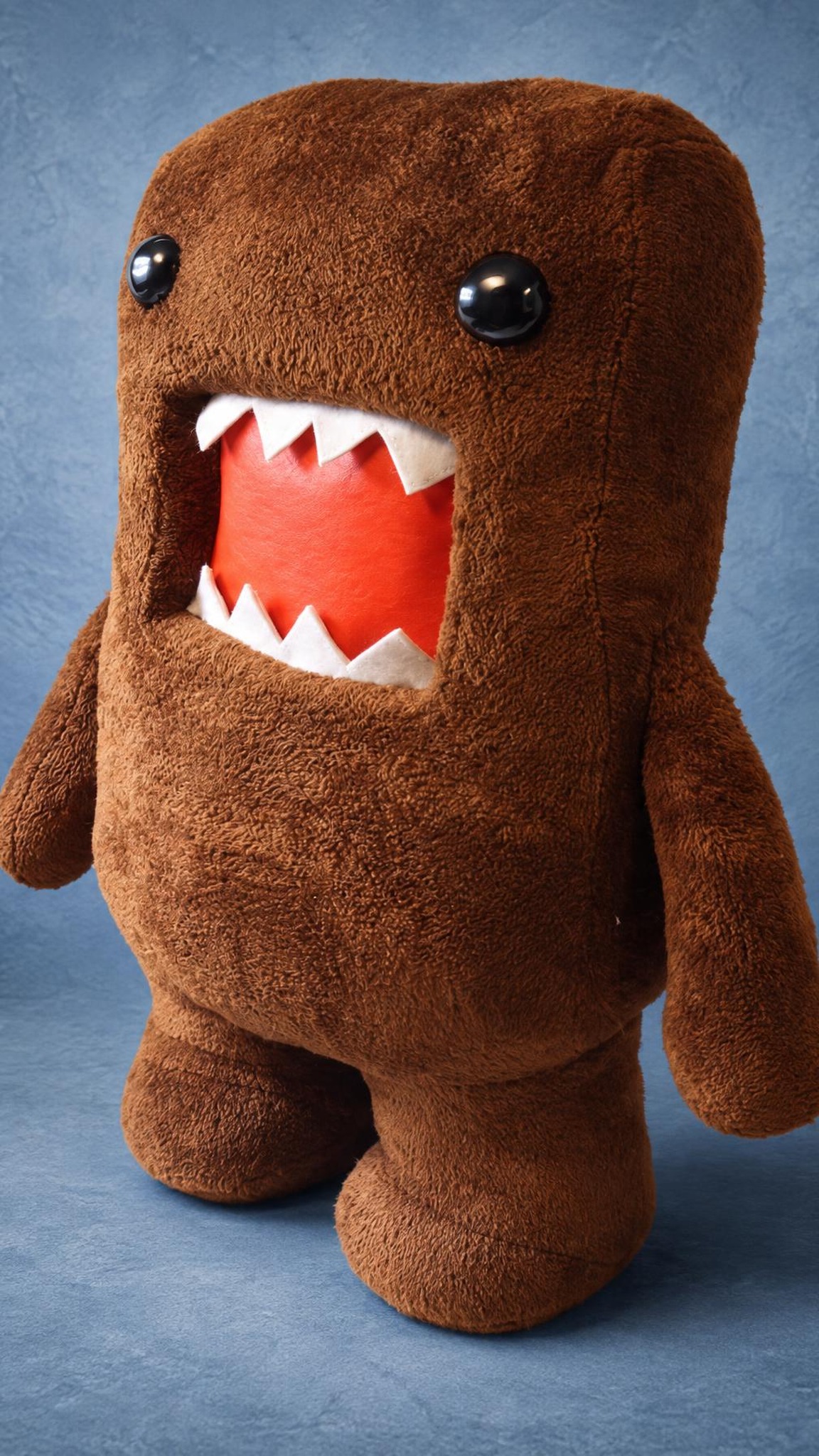 Domo-kun plush from the side, boxy brown fleece body with short arms, a custom NHK monster made to order