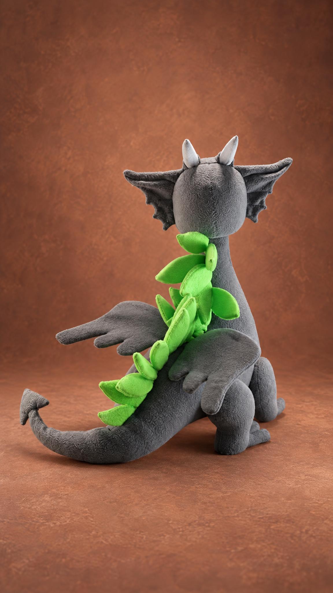 Dragon mascot plush from behind: a row of lime-green fleece spikes, gray bat wings and an arrow tail, handmade
