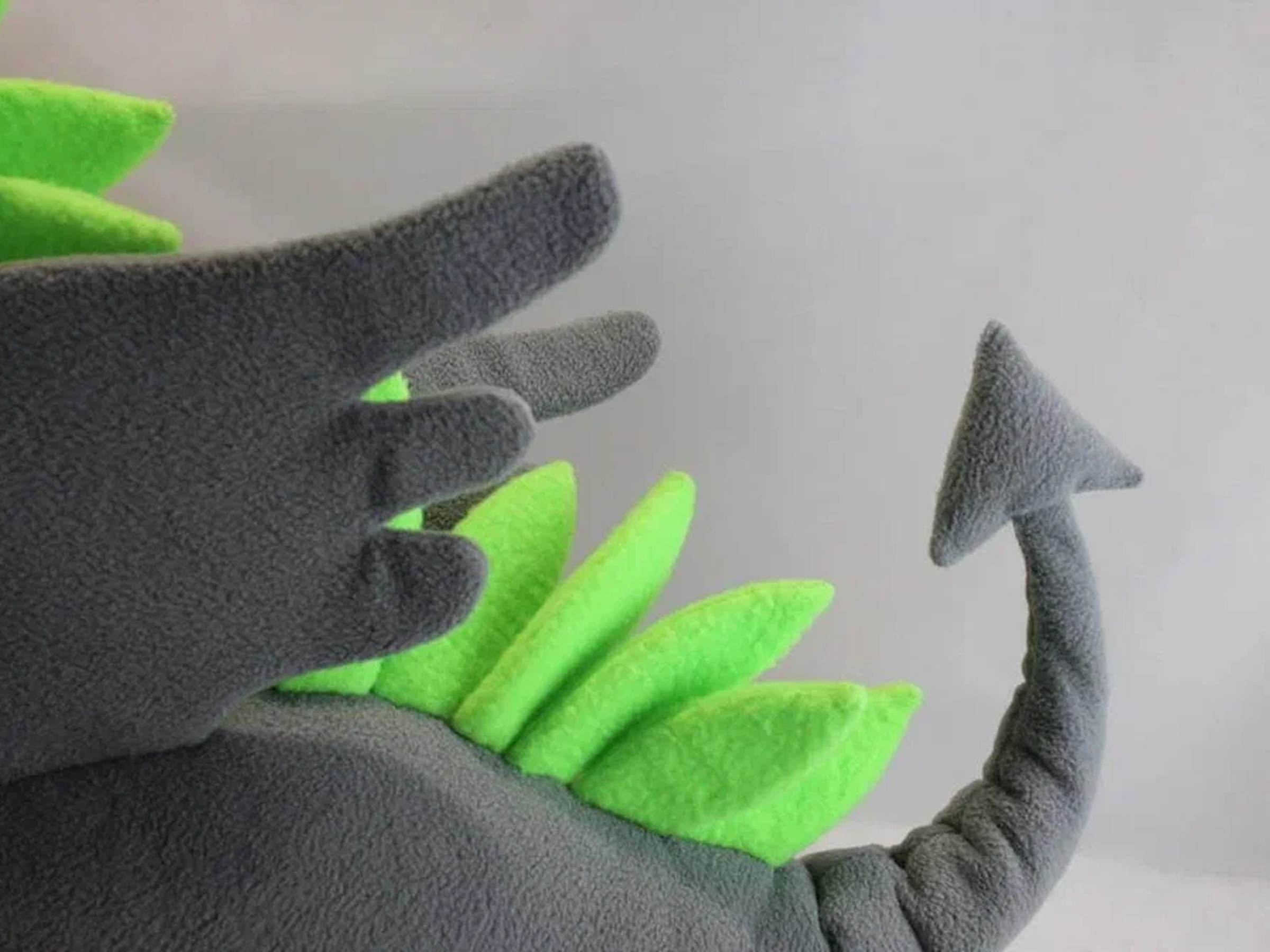 Dragon mascot plush wing and arrow tail Dragon mascot plush wing, lime-green spikes and arrow-tipped tail in gray fleece, a custom plush sewn by hand