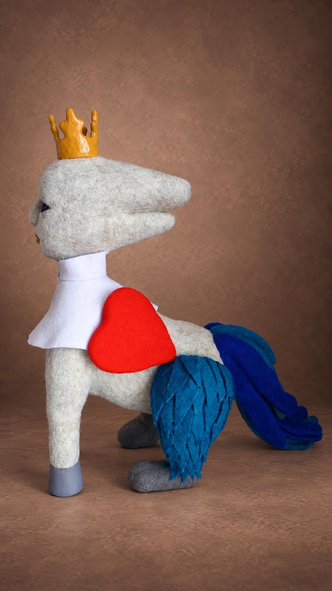Felted fantasy creature toy with a red heart and blue feathers, a custom character plush made to order