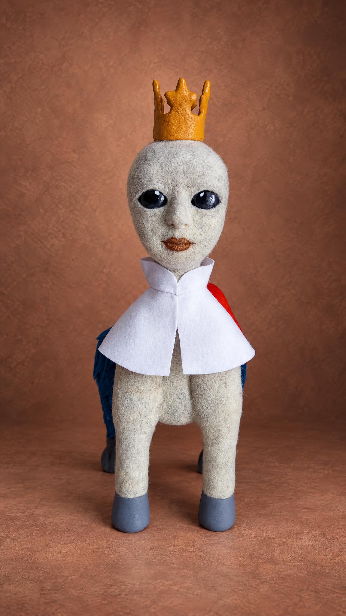 Custom felted fantasy creature with a crown and white cape, a character toy made to order from art
