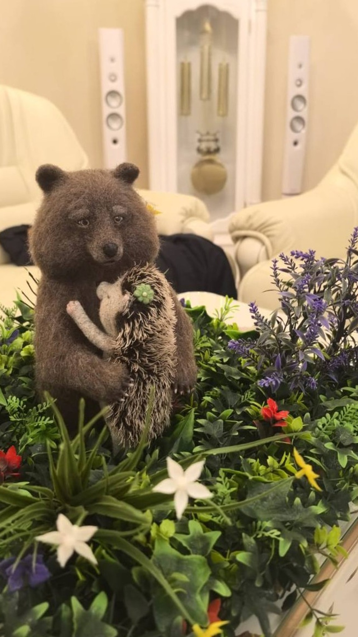 Handmade felted bear and hedgehog among green plants and flowers, a custom gift for a girlfriend made to order