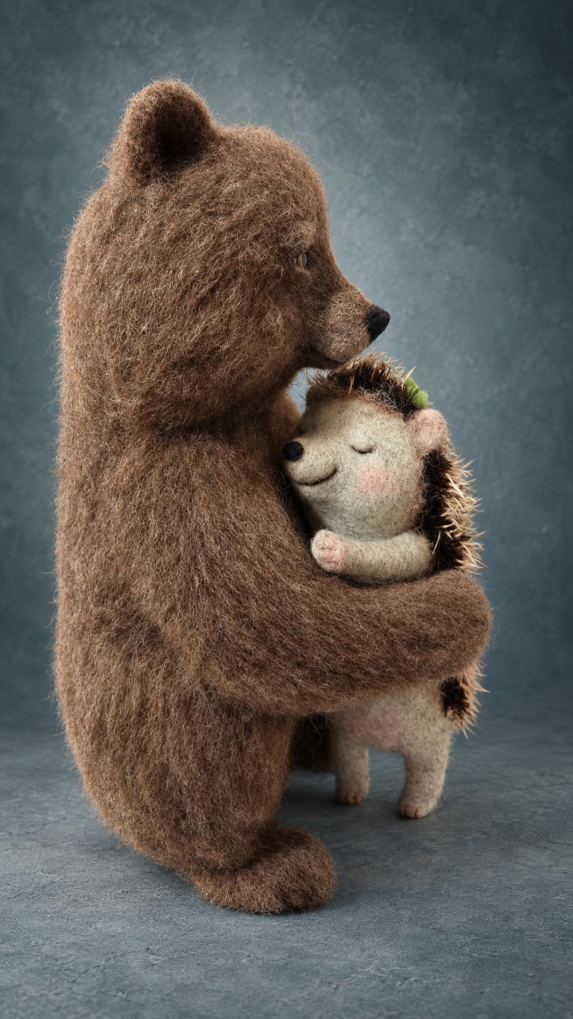 Needle felted brown bear with fuzzy wool fur hugging a sleepy hedgehog, handmade to order as a romantic gift