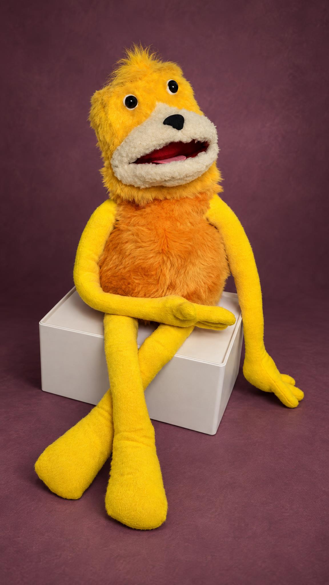 Custom Flat Eric plush puppet made to order, open mouth, orange fur body and long yellow legs crossed