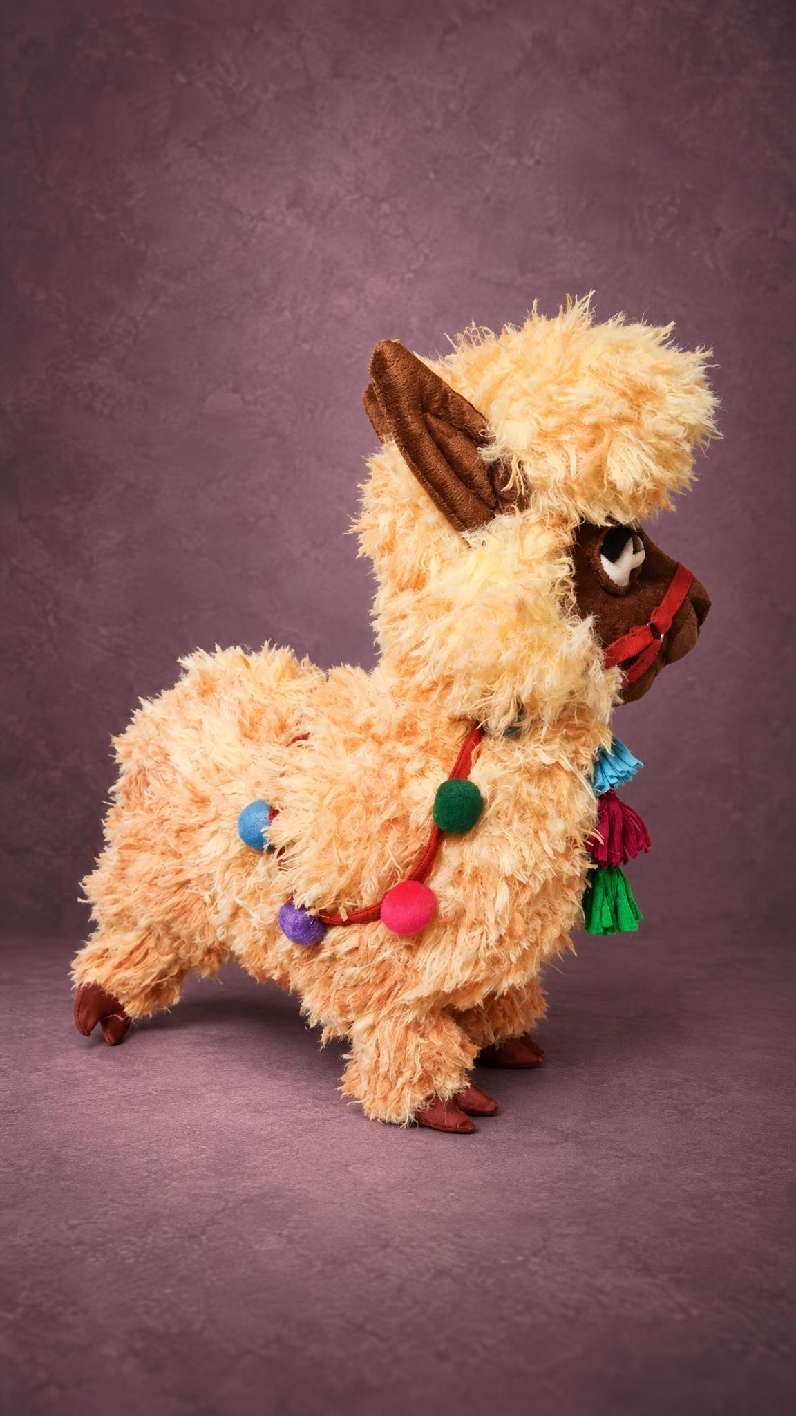 Custom stuffed llama with curly apricot fur, brown ears and bright Andean-style tassels, made to order