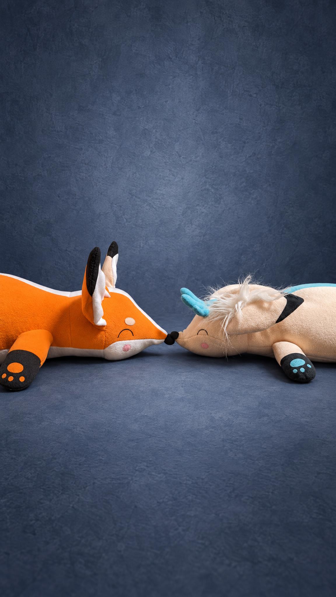 Matching fox plushies for a couple lying nose to nose, handmade to order from the couple's own picture