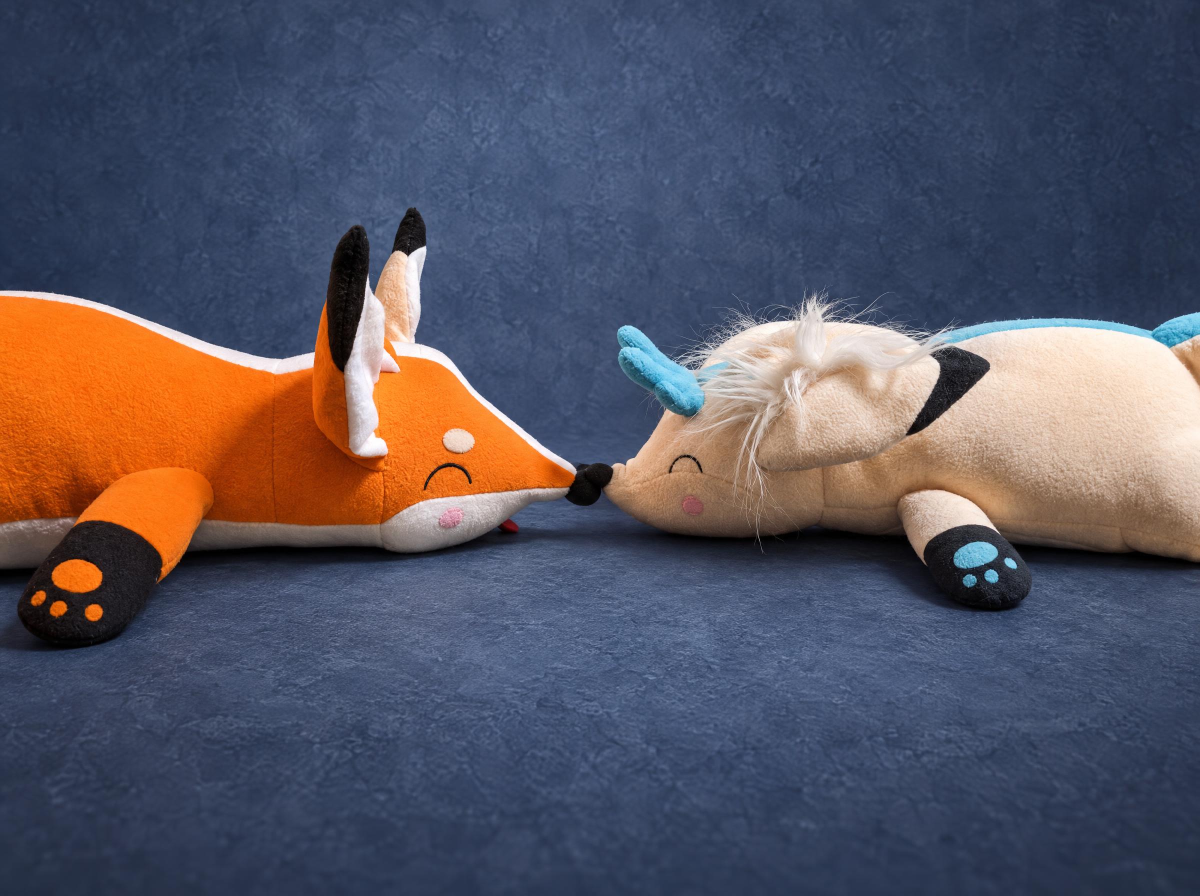 Fox couple plushies, an orange fox and a cream fox with turquoise antlers touching noses, sewn to order