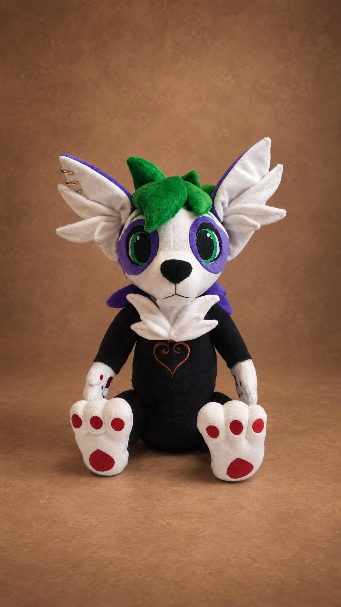 Custom fursona plush of a white OC with purple eye patches, green hair and winged ears, handmade to order