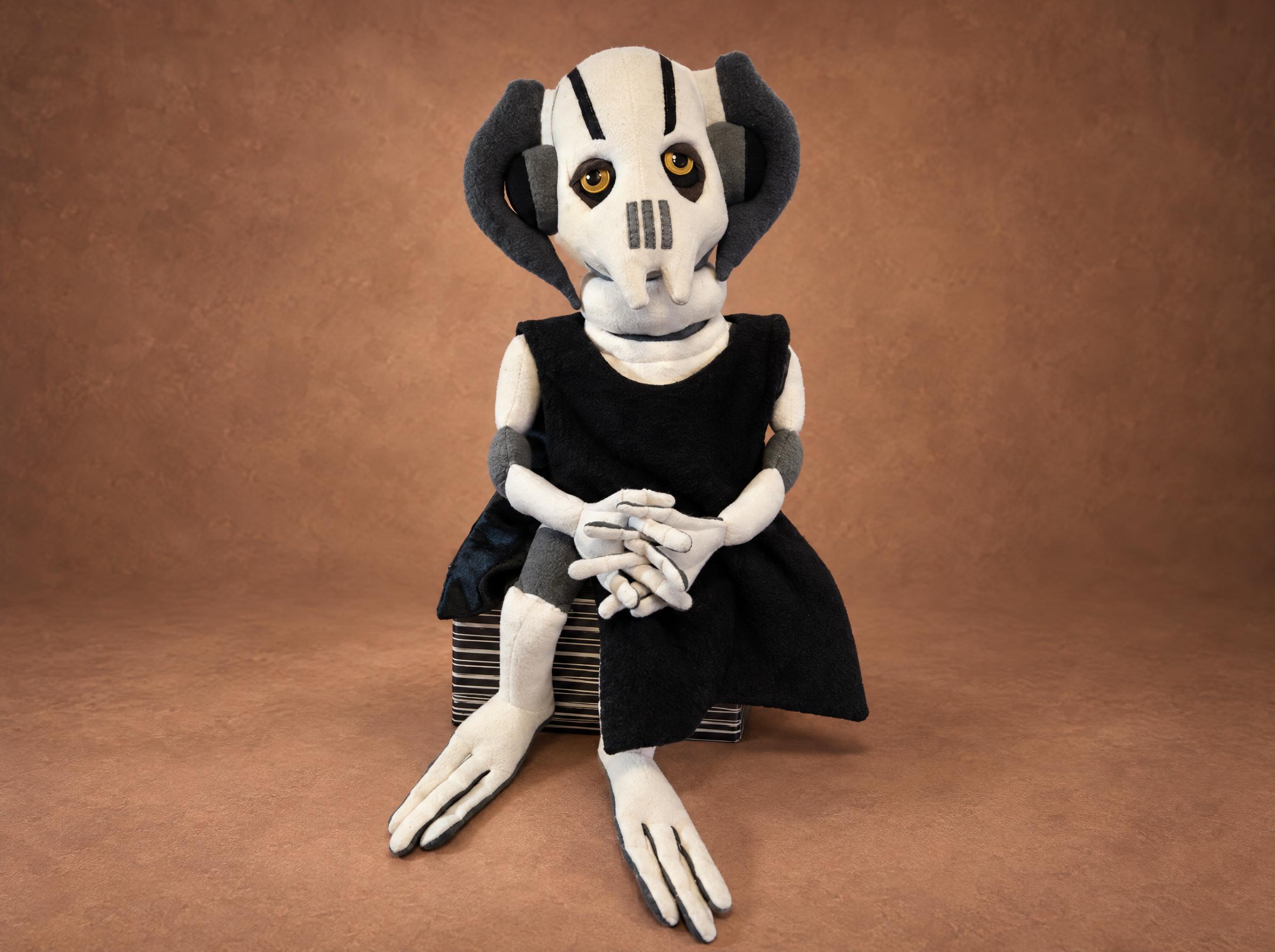 General Grievous plush toy in a black cloak General Grievous plush toy with a white mask, amber eyes and a black cloak, long fingers folded, made to order