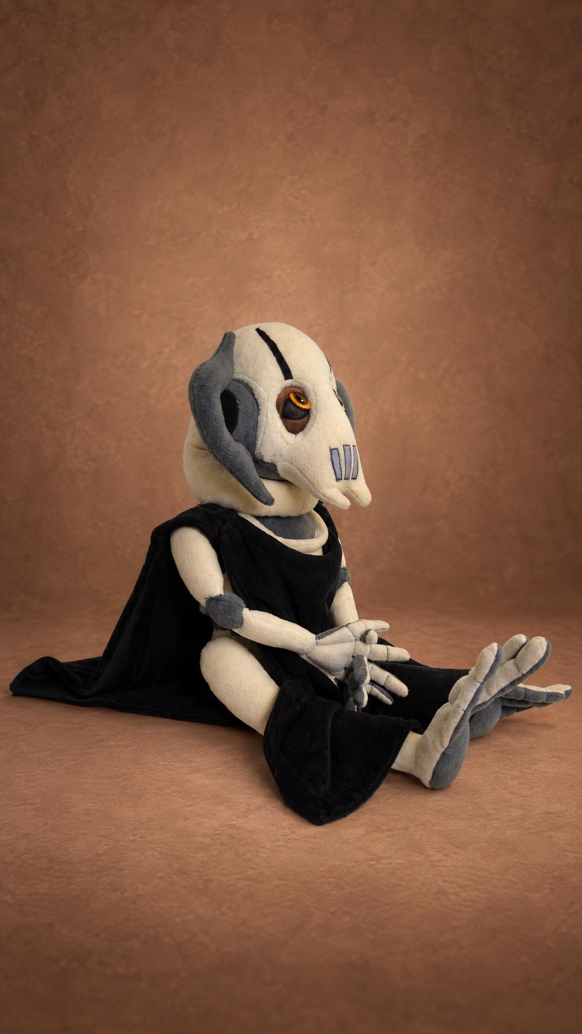 Handmade General Grievous plush sitting in his cloak, long cream fingers folded, sewn to order for one fan