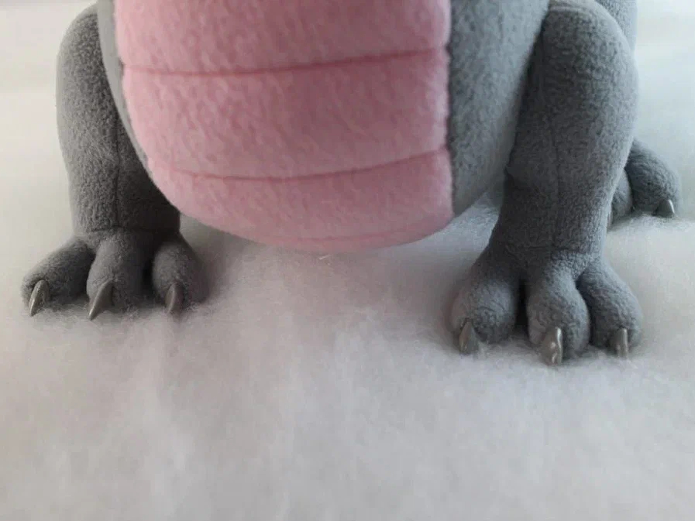 Gray dragon plush paws and claws Gray dragon plush paws with small claws under a pink ribbed belly, a handmade dragon mascot made to order