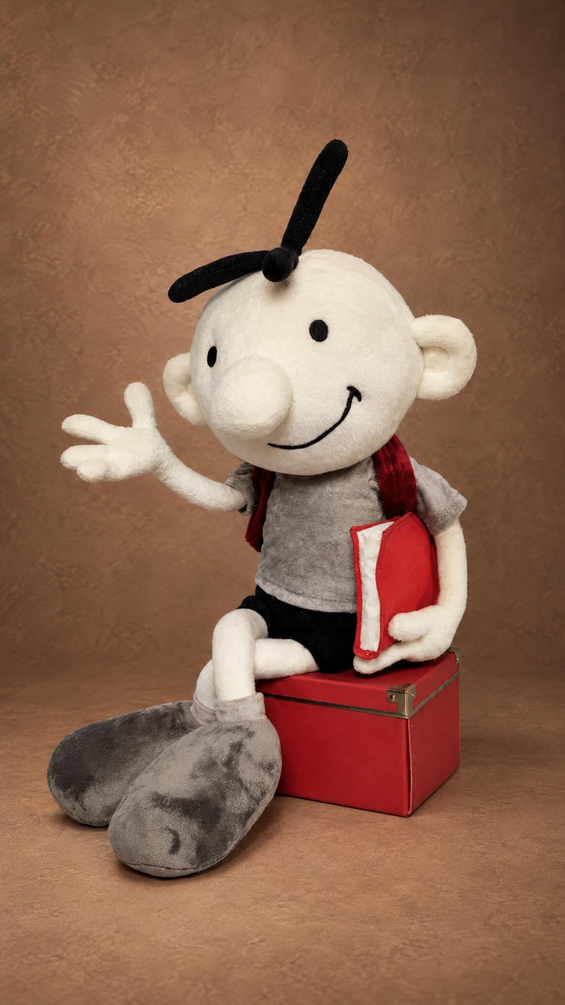 Custom Greg Heffley doll sitting on a red box and waving, a handmade Diary of a Wimpy Kid plush made to order