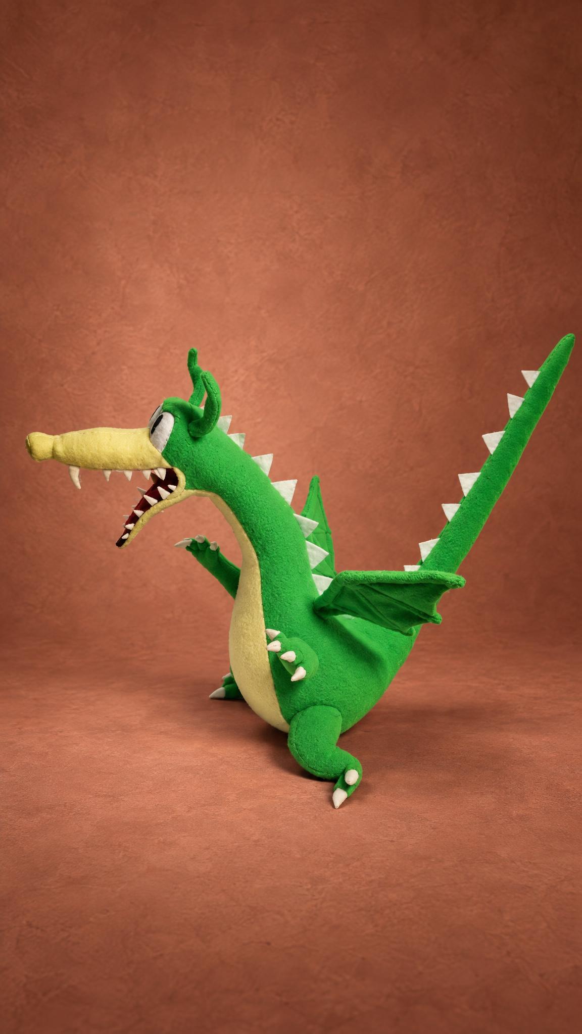 Grim Matchstick plush from Cuphead stretching his long green neck and tail, a custom handmade dragon toy