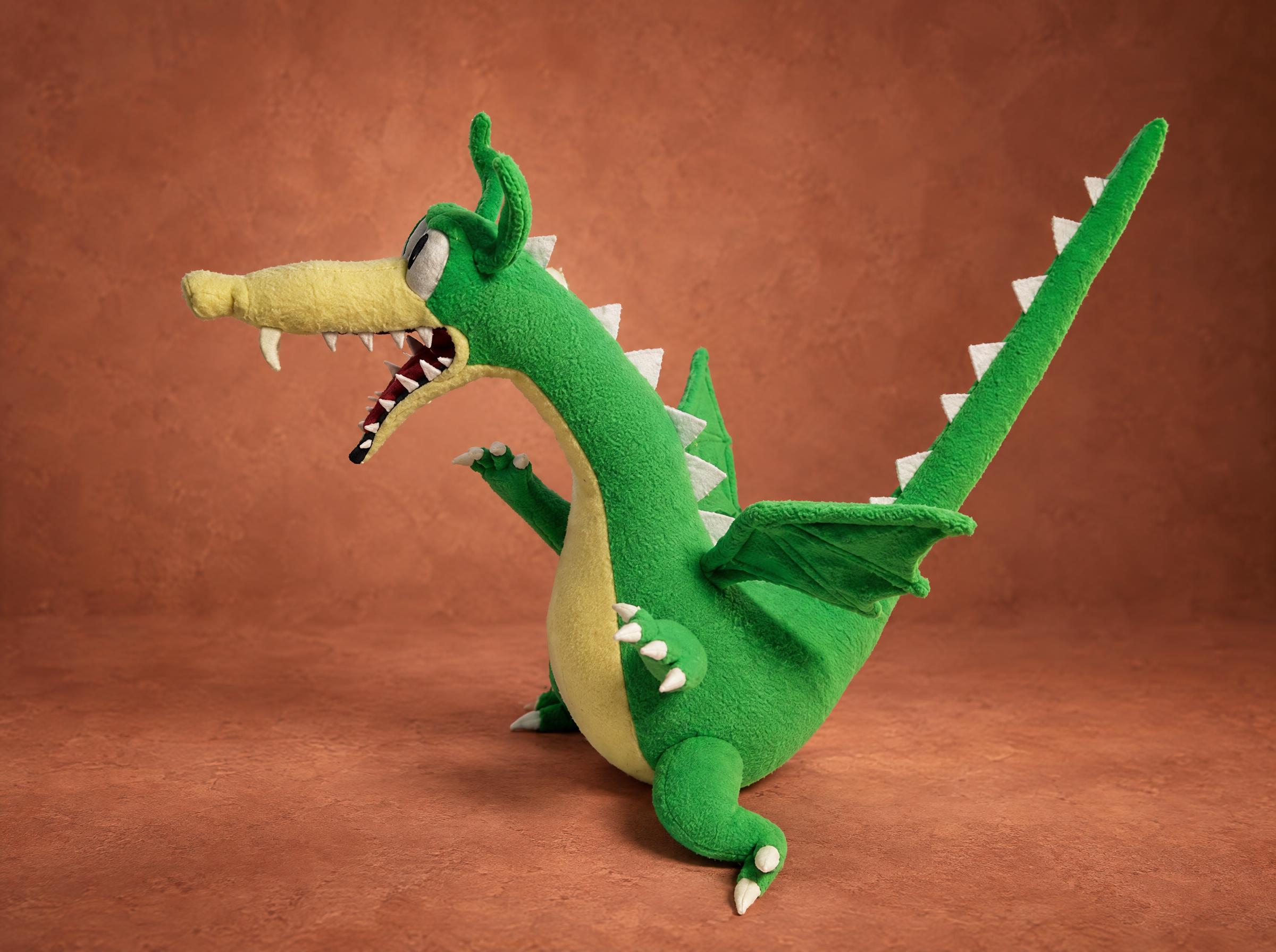 Grim Matchstick Plush Long Neck Grim Matchstick plush from Cuphead stretching his long green neck and tail, a custom handmade dragon toy