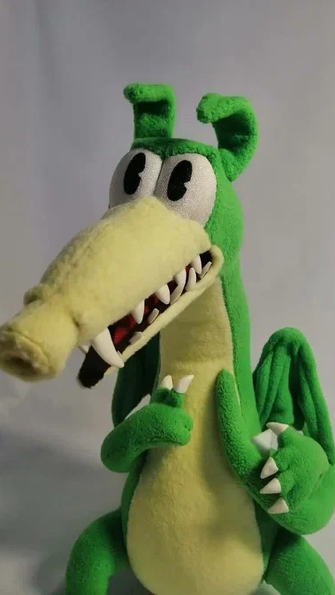 Handmade Grim Matchstick plush with a long yellow snout, white teeth and big eyes, a custom Cuphead dragon