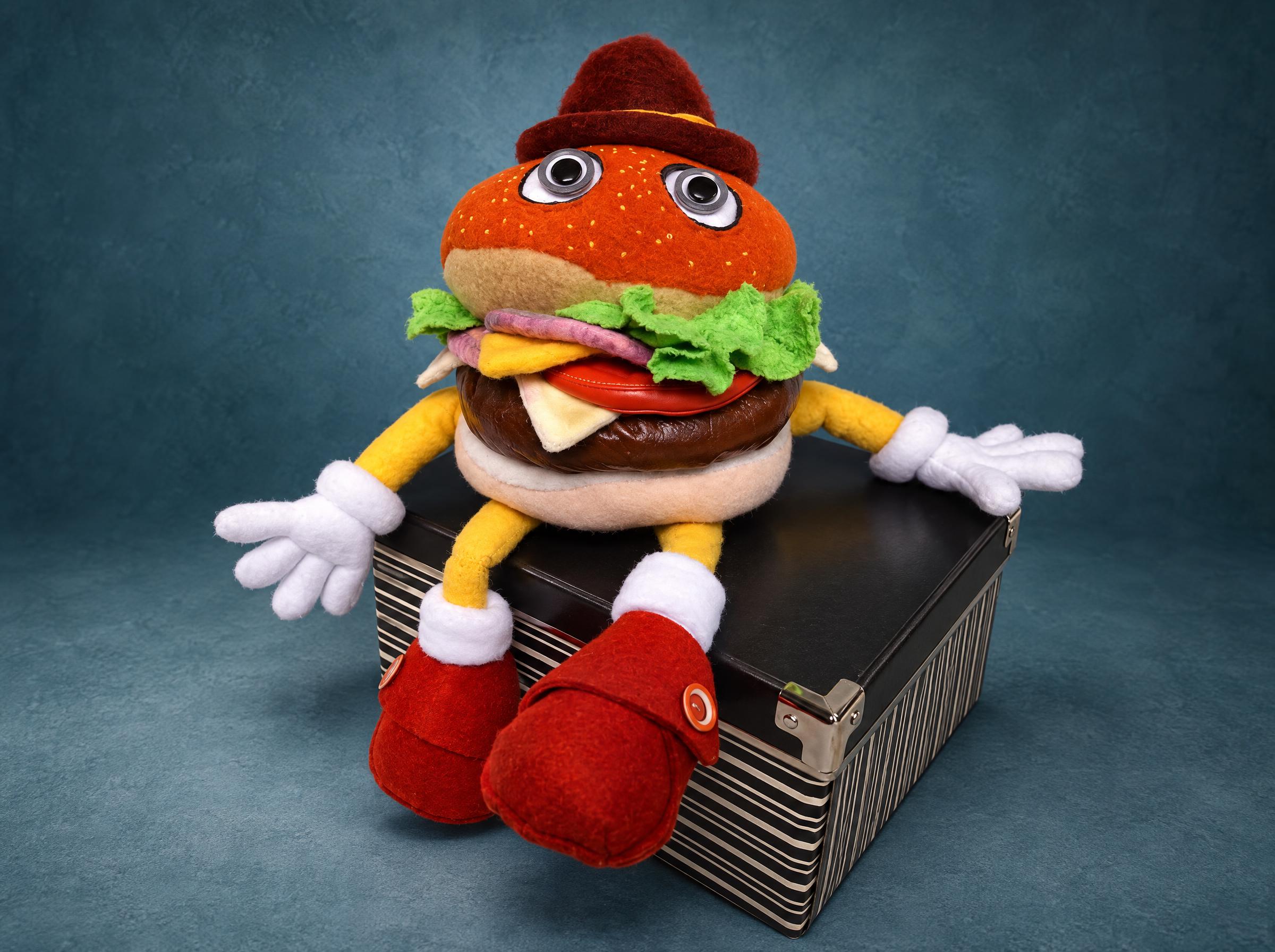 Hamburger man plush sewn from a customer's drawing: googly eyes, maroon felt hat, fabric lettuce, big red shoes